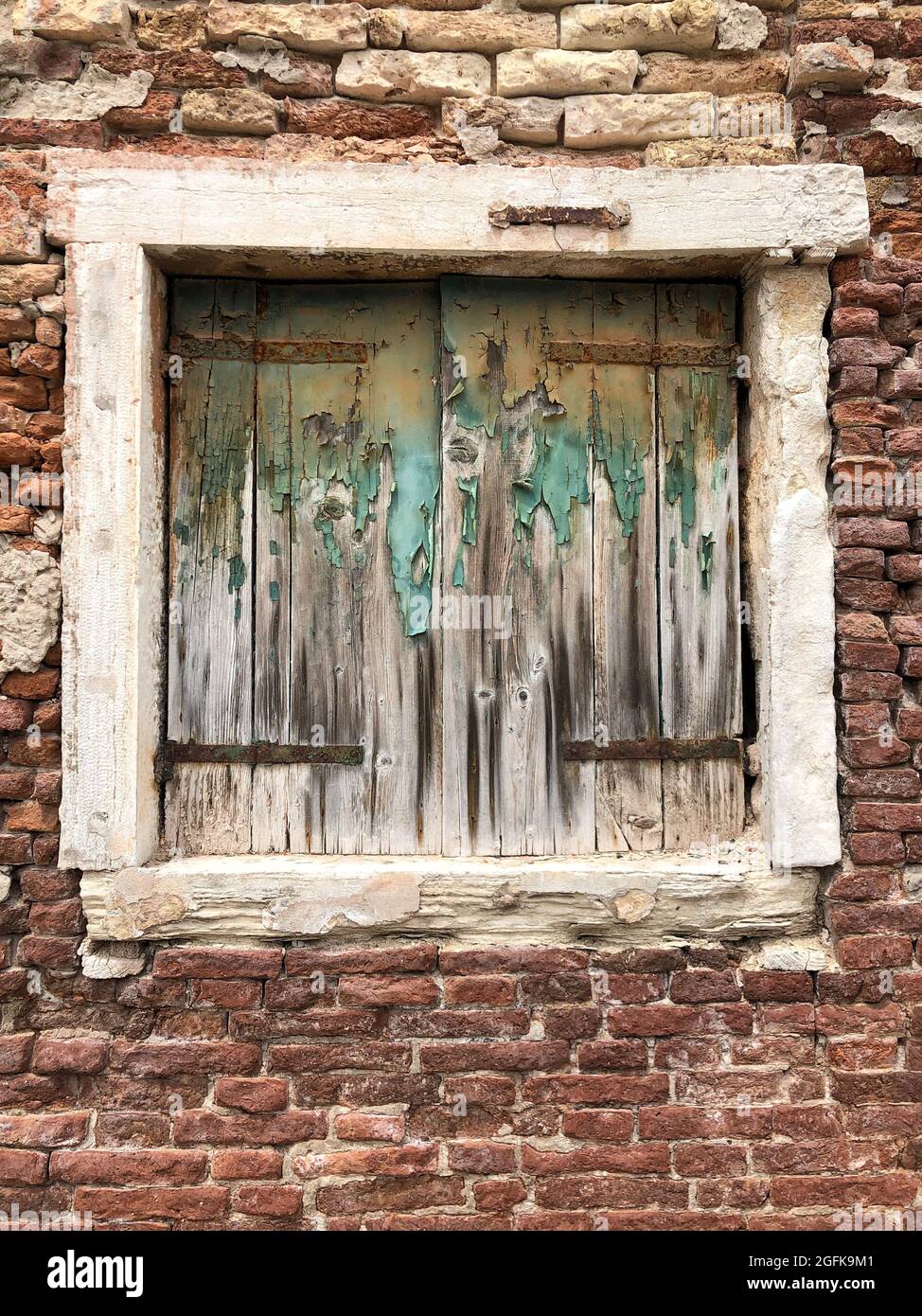 closed window blinds of an old brick house Stock Photo