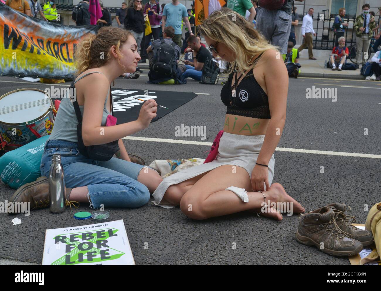 An activist having her body painted during the demonstration. Climate change activists from Extinction Rebellion demonstrate at Parliament Street. Stock Photo