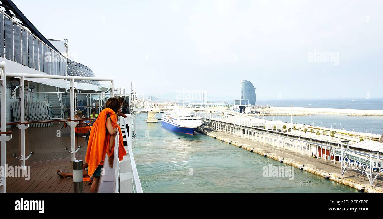 Deck of a cruise ship with people saying goodbye in the port of