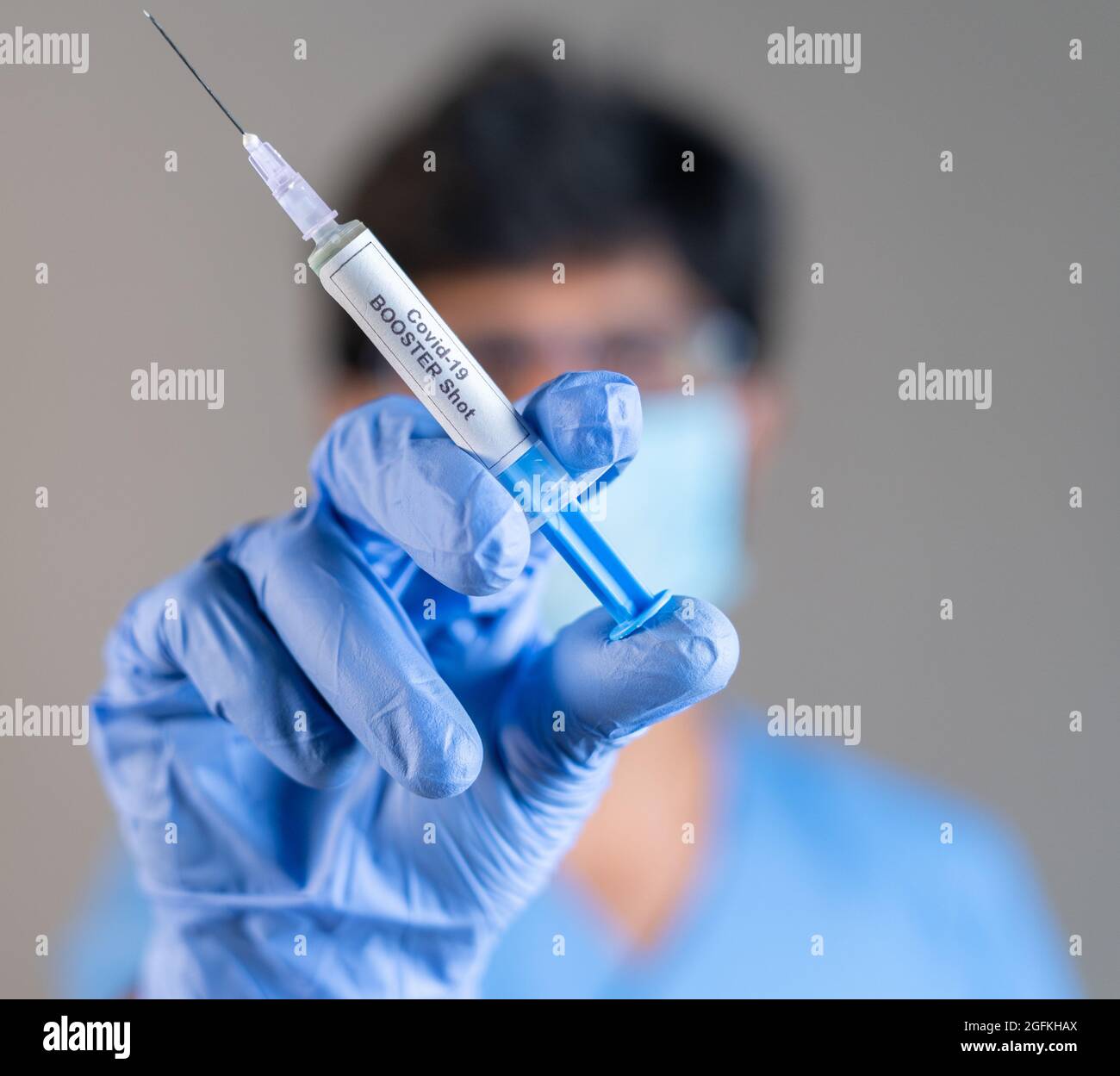 Focus on syringe, close up of doctor or nurse hands holding covid vaccination booster shot or 3rd dose syringe. Stock Photo