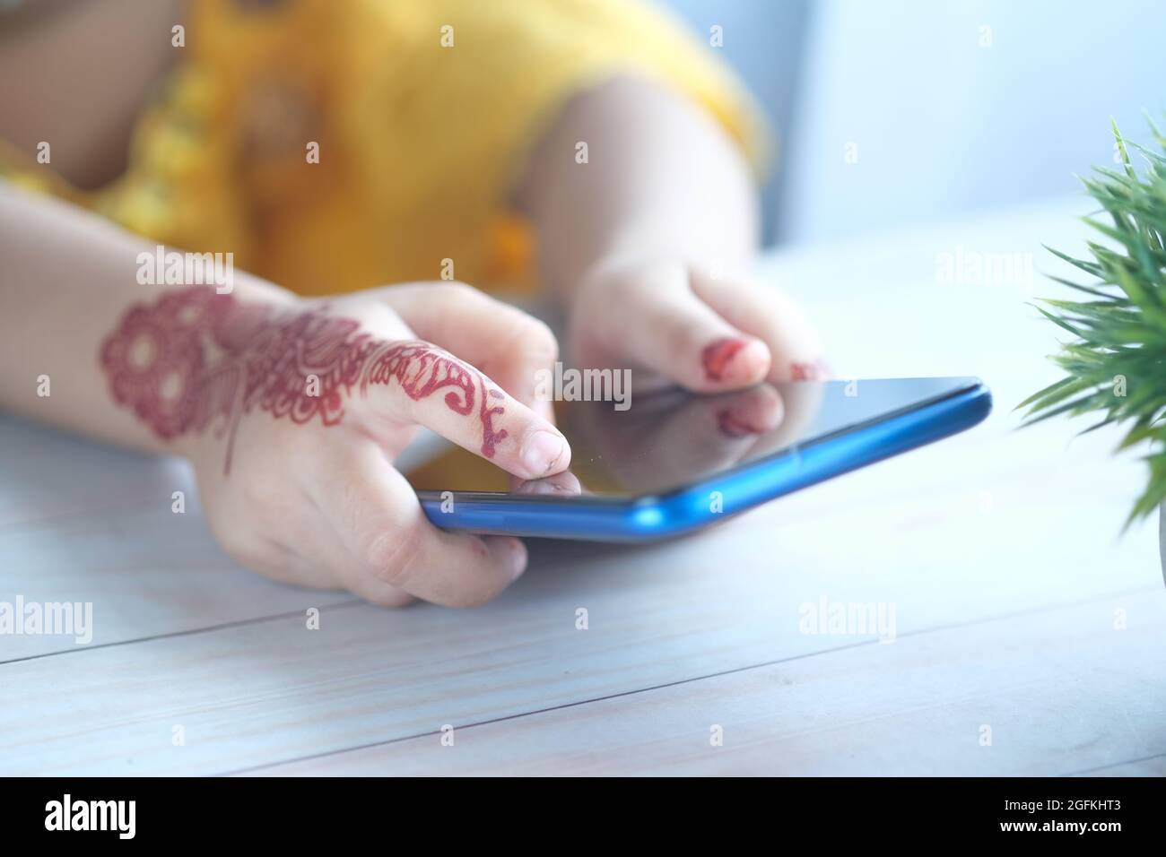 child girl using smart phone on table  Stock Photo