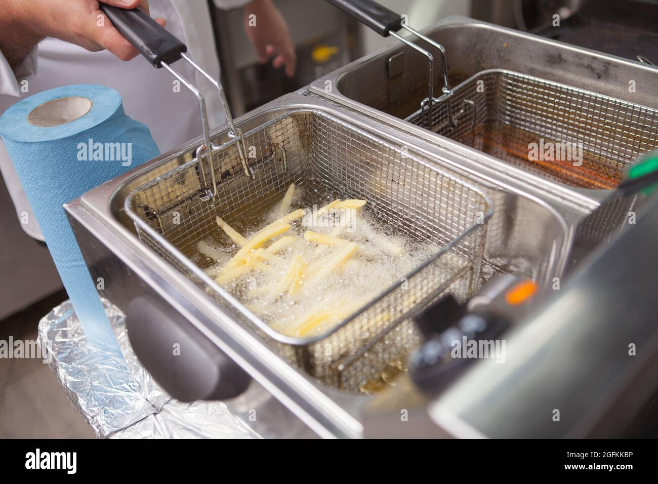 Chef frying french fries in hot oil Stock Photo Alamy