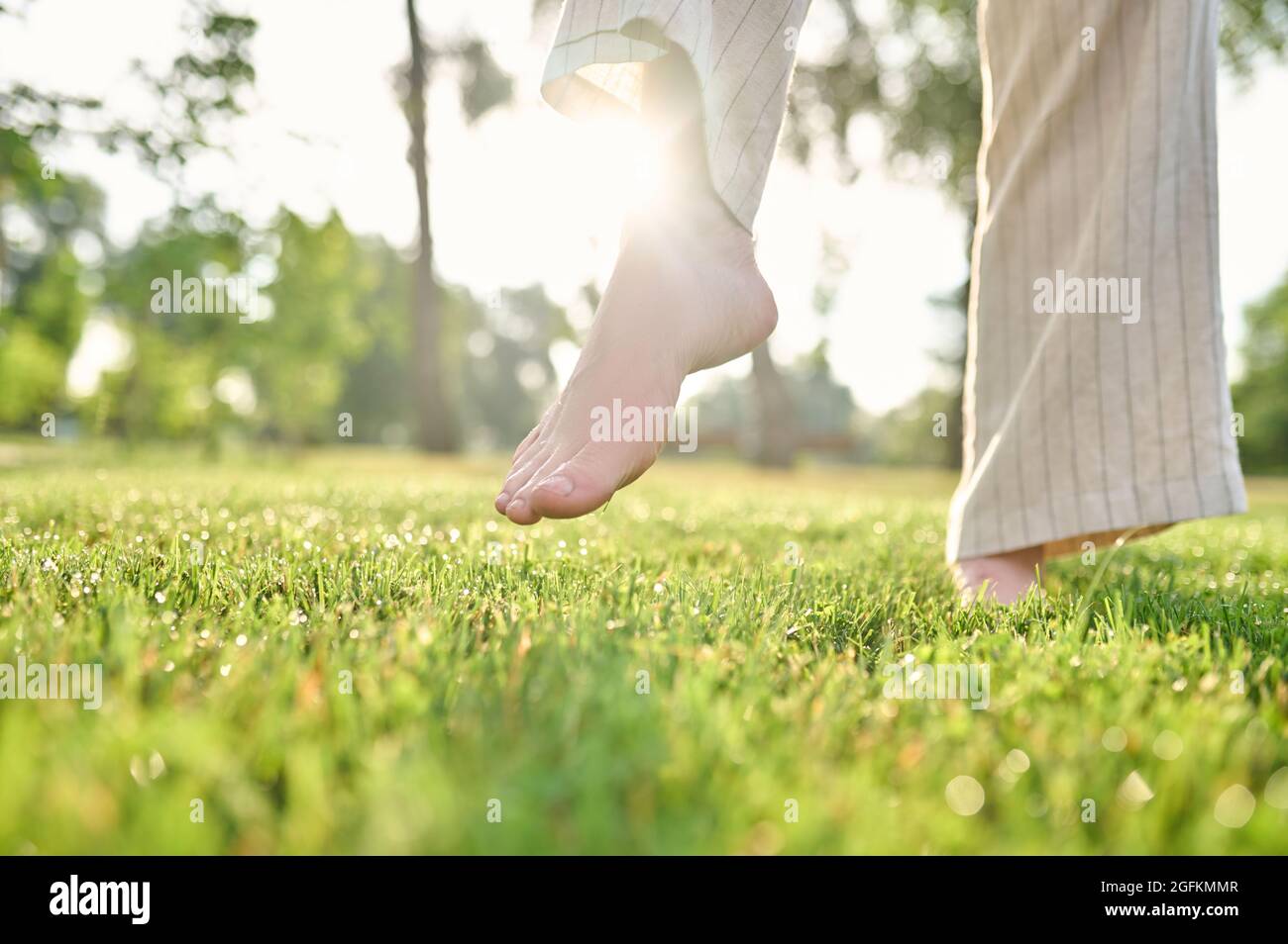 Female walking barefoot in grass hi-res stock photography and images ...