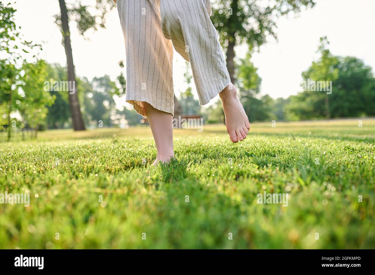 Womens legs joyfully moving on grass Stock Photo