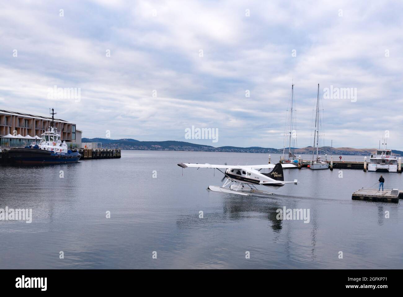 A de Havilland Beaver seaplane motors out from Constitution Dock on the Derwent River in Hobart, Tasmania, Australia on a scenic charter flight Stock Photo