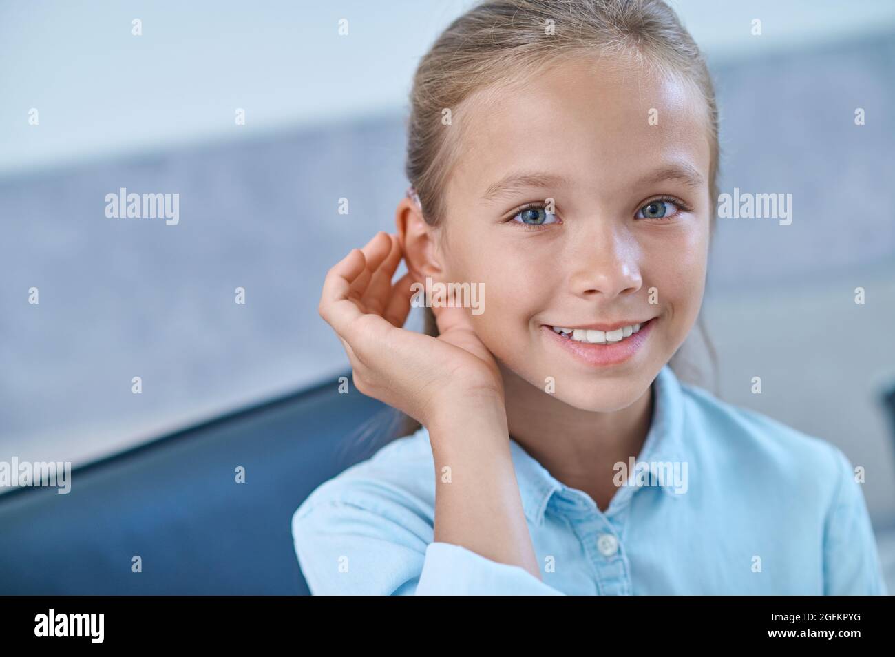 Hearing impaired girl trying hearing aid Stock Photo Alamy