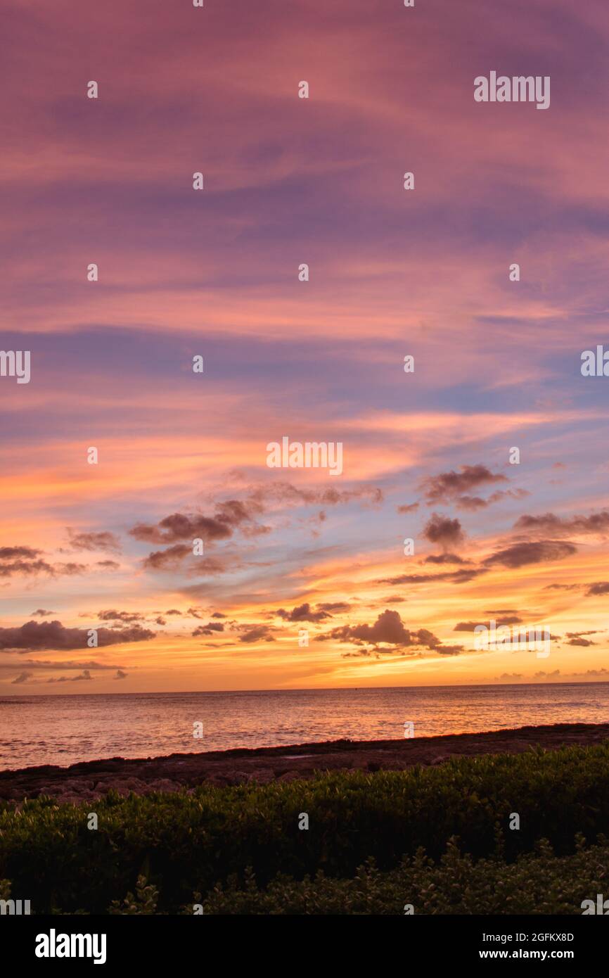 Rainbow Hawaiian cloudy sunset beach Stock Photo