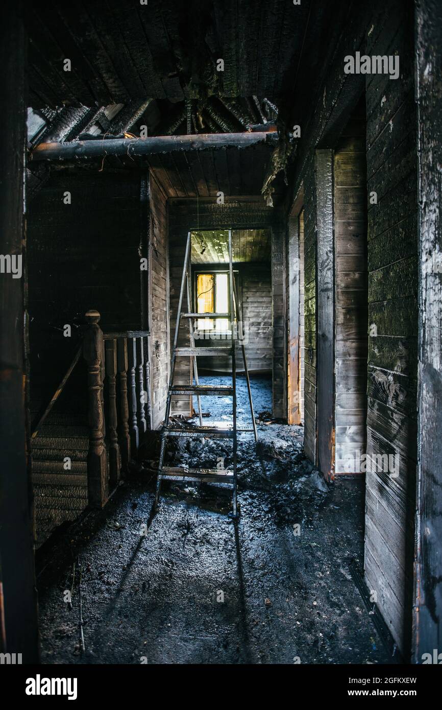 Burnt wooden house interior. Charred walls. Consequences of fire Stock