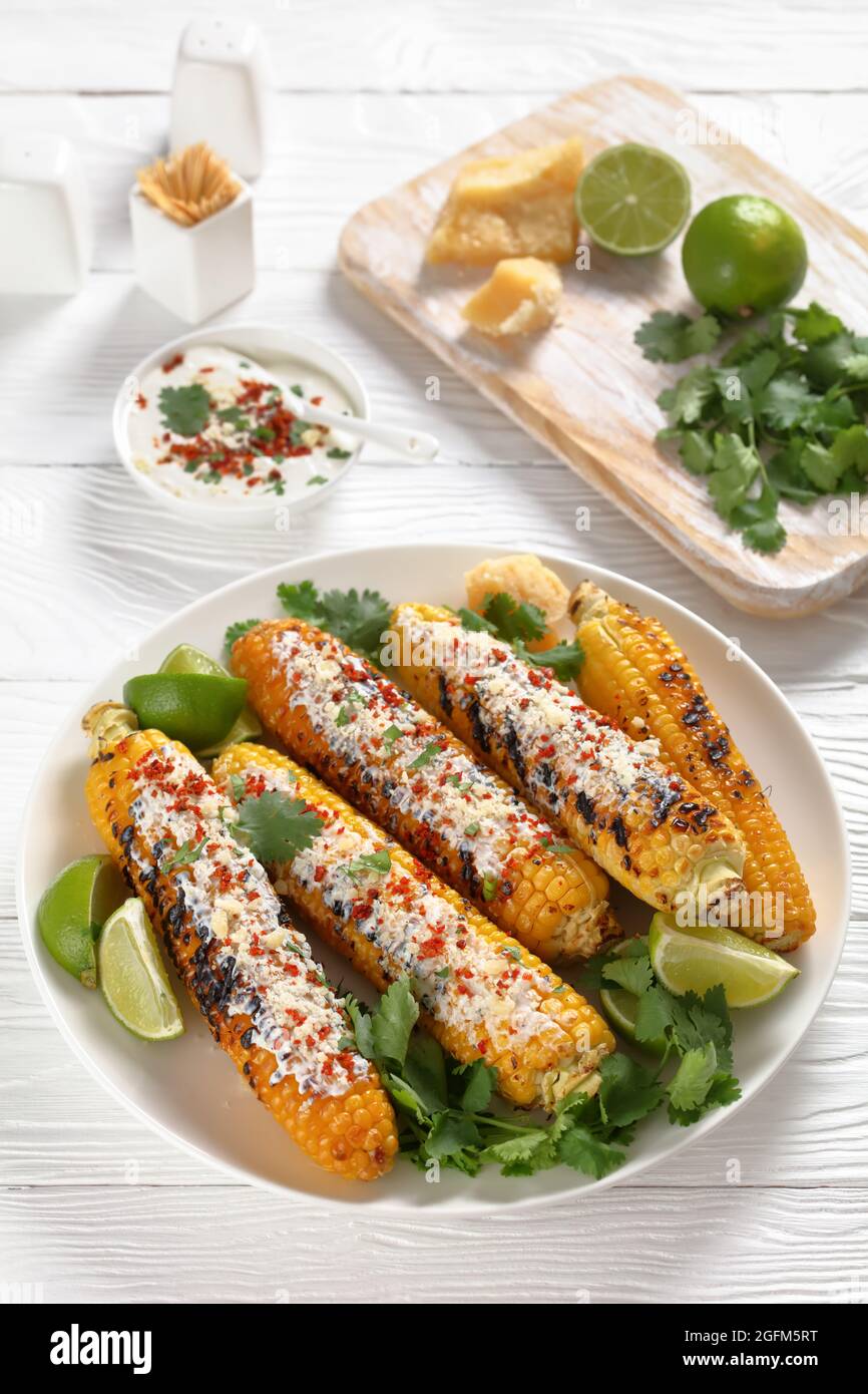 Elotes, Grilled Mexican Street Corn, charred cobs are covered in creamy
