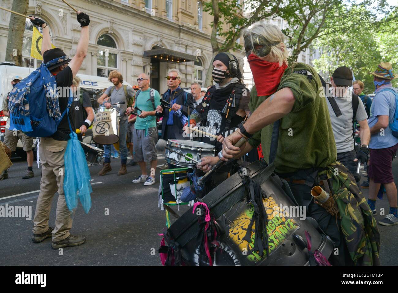 Extinction Rebellion protesters hold drums while marching from Piccadilly Circus to Oxford Street during the demonstration. Stock Photo