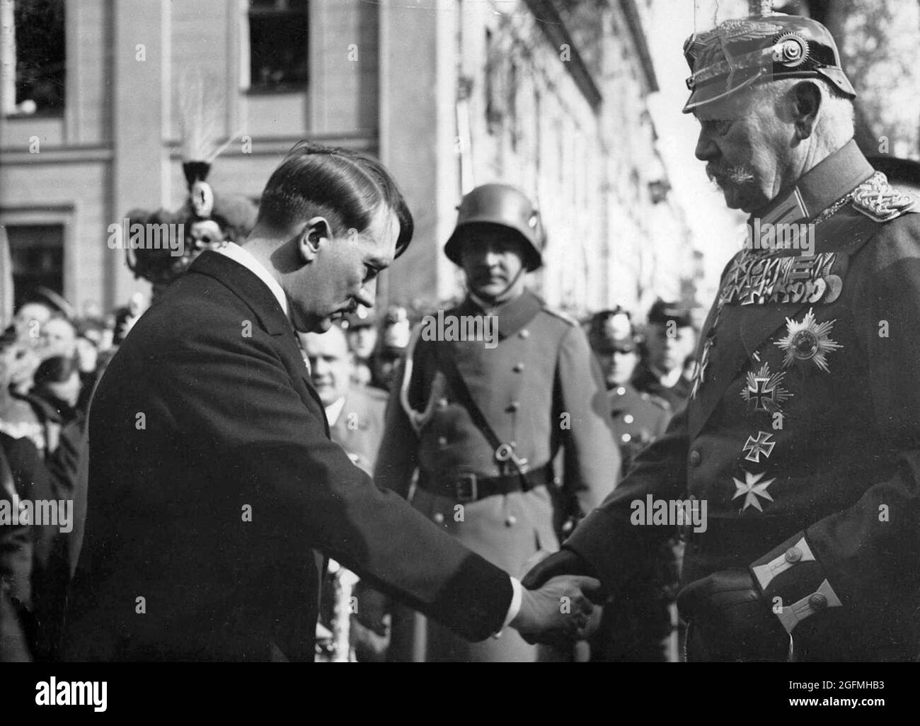 Hitler shaking hands and bowing to Paul von Hindenburg on the Day of Potsdam, 21 March 1933. This seeming gesture of respect and humility did much to allay HIndenberg's and the public's fears and hence allowed Hitler to persuade the Reichstag to pass The Enabling Act (which gave Hitler the right to act by decree without parliament) two days later with little opposition.Credit: German Bundesarchiv Stock Photo