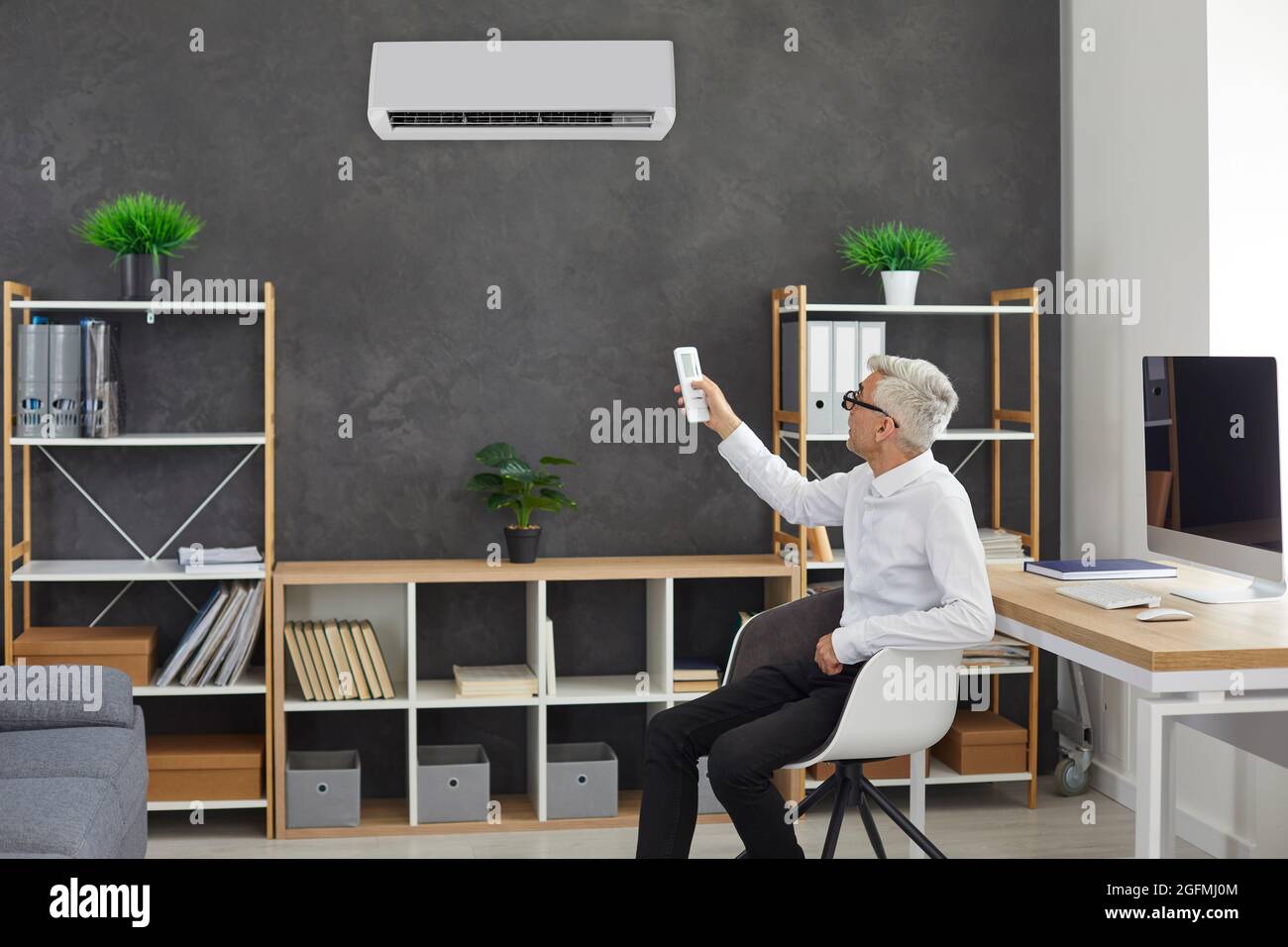 Man turn air conditioner for fresh ventilated air Stock Photo