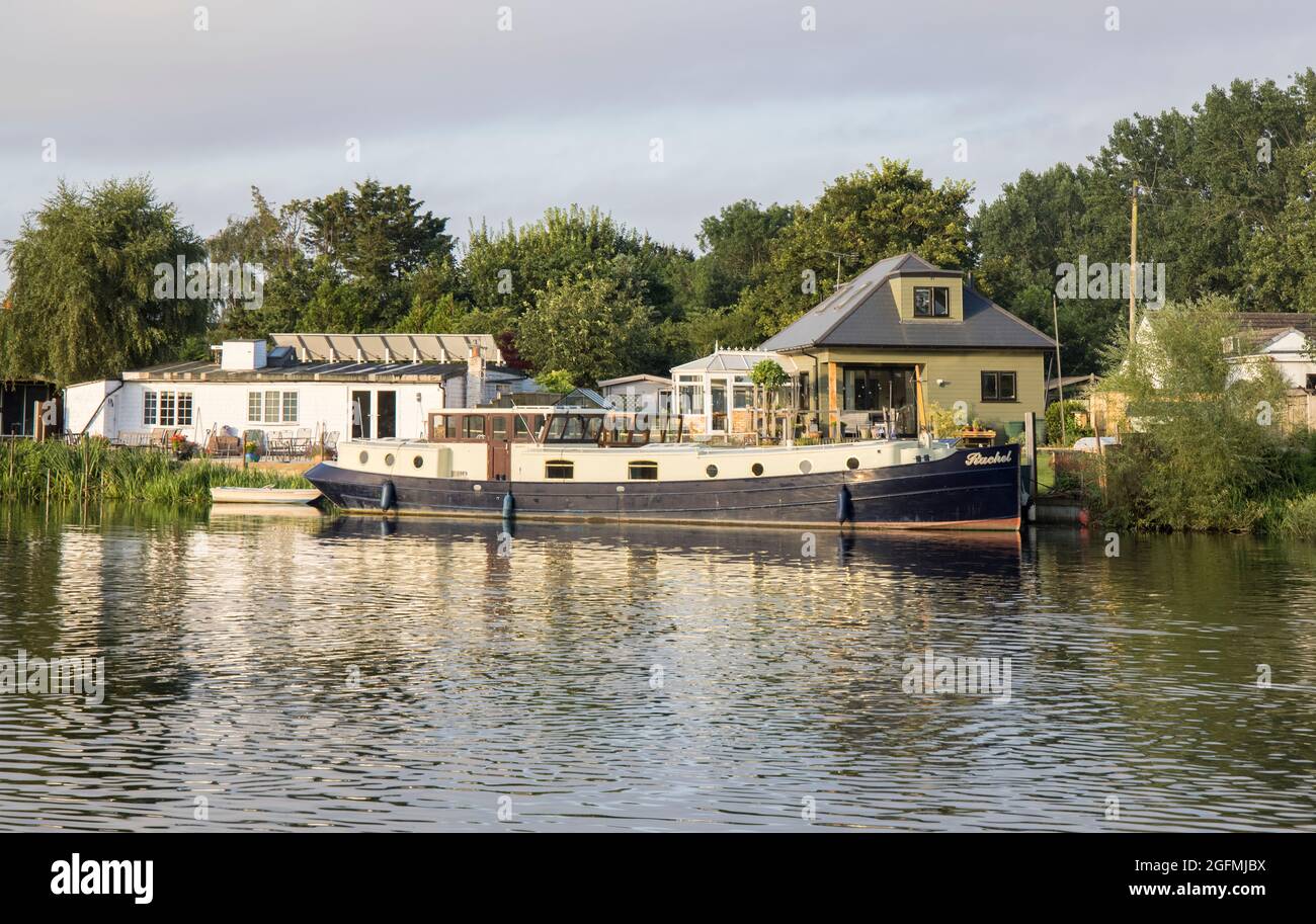 moored boats and houses on the banks of  the river thames at laleham in surrey Stock Photo