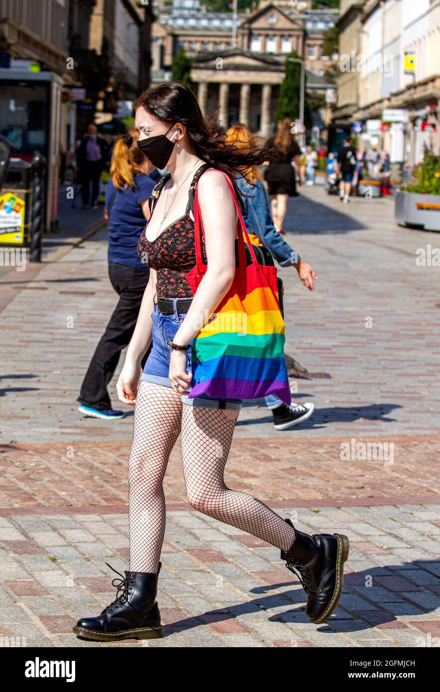 Dundee, Tayside, Scotland, UK. 26th Aug, 2021. UK Weather: A warm sunny day with a slight cool breeze across North East Scotland with temperatures reaching 20°C. A young glamorous woman wearing a facemask walking in the warm sunshine whilst enjoying a day out in Dundee city centre. Credit: Dundee Photographics/Alamy Live News Stock Photo