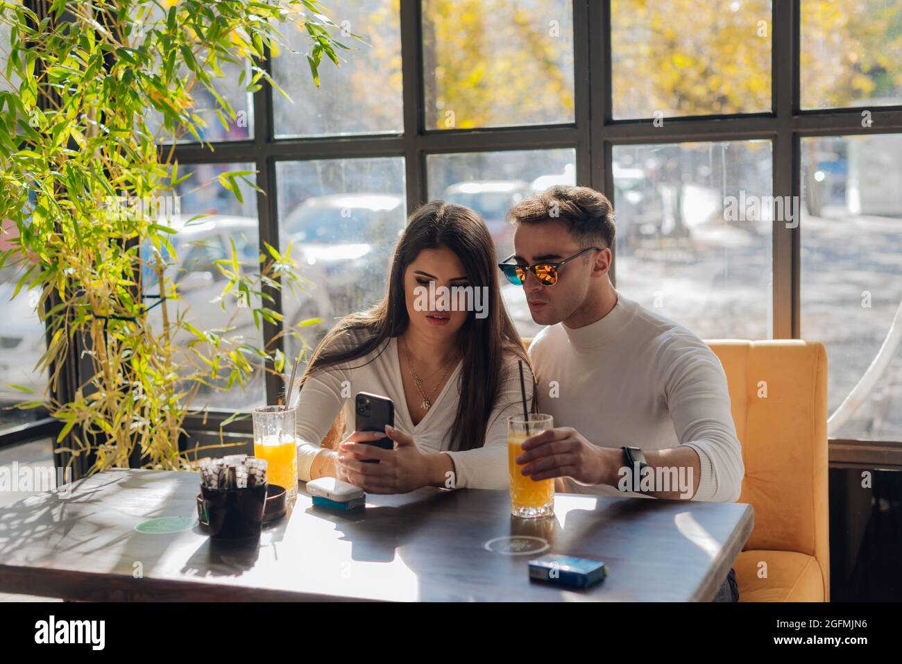 Friends socializing, having fun, and laughing drinking coffee in