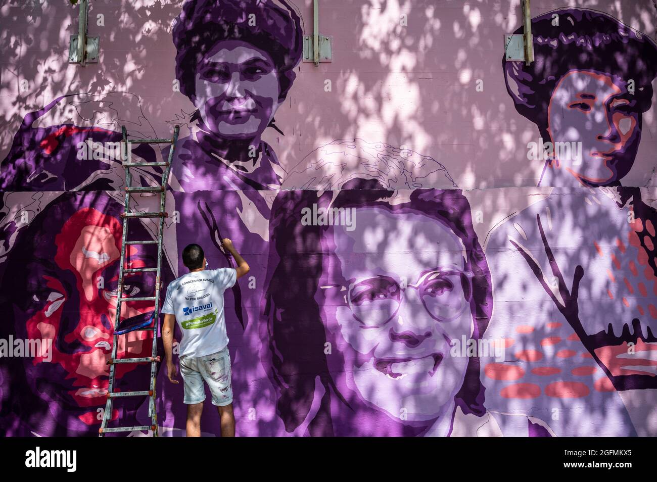 Madrid, Spain, 26/08/2021, Madrid, Spain. 26th Aug, 2021. A member of UNLOGIC artistic group repainting a feminist mural that appeared vandalized during the past International Women's Day. The mural represents famous women from around the world, with the faces of 15 women who are part of history for their fight in favor of equality: Angela Davis, Frida Kahlo, Nina Simone, Rigoberta Menchu, Lucia Sanchez Saornil, Rosa Arauzo, Valentina Tereshkova, Chimamanda Ngozi, Emma Goldman, Kanno Sugato, Liudmila Pavlichenko, Billy Jean King, Gata Cattana, Rosa Parks, and Comandanta Ramona. Credit: Marcos  Stock Photo