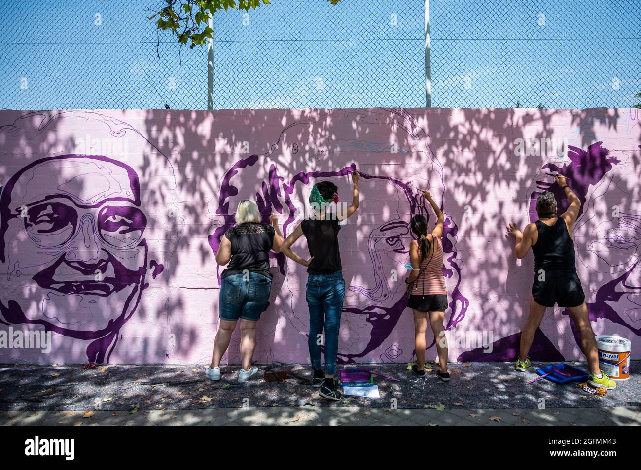 Madrid, Spain, 26/08/2021, Madrid, Spain. 26th Aug, 2021. Members of UNLOGIC artistic group repainting a feminist mural that appeared vandalized during the past International Women's Day. The mural represents famous women from around the world, with the faces of 15 women who are part of history for their fight in favor of equality: Angela Davis, Frida Kahlo, Nina Simone, Rigoberta Menchu, Lucia Sanchez Saornil, Rosa Arauzo, Valentina Tereshkova, Chimamanda Ngozi, Emma Goldman, Kanno Sugato, Liudmila Pavlichenko, Billy Jean King, Gata Cattana, Rosa Parks, and Comandanta Ramona. Credit: Marcos d Stock Photo