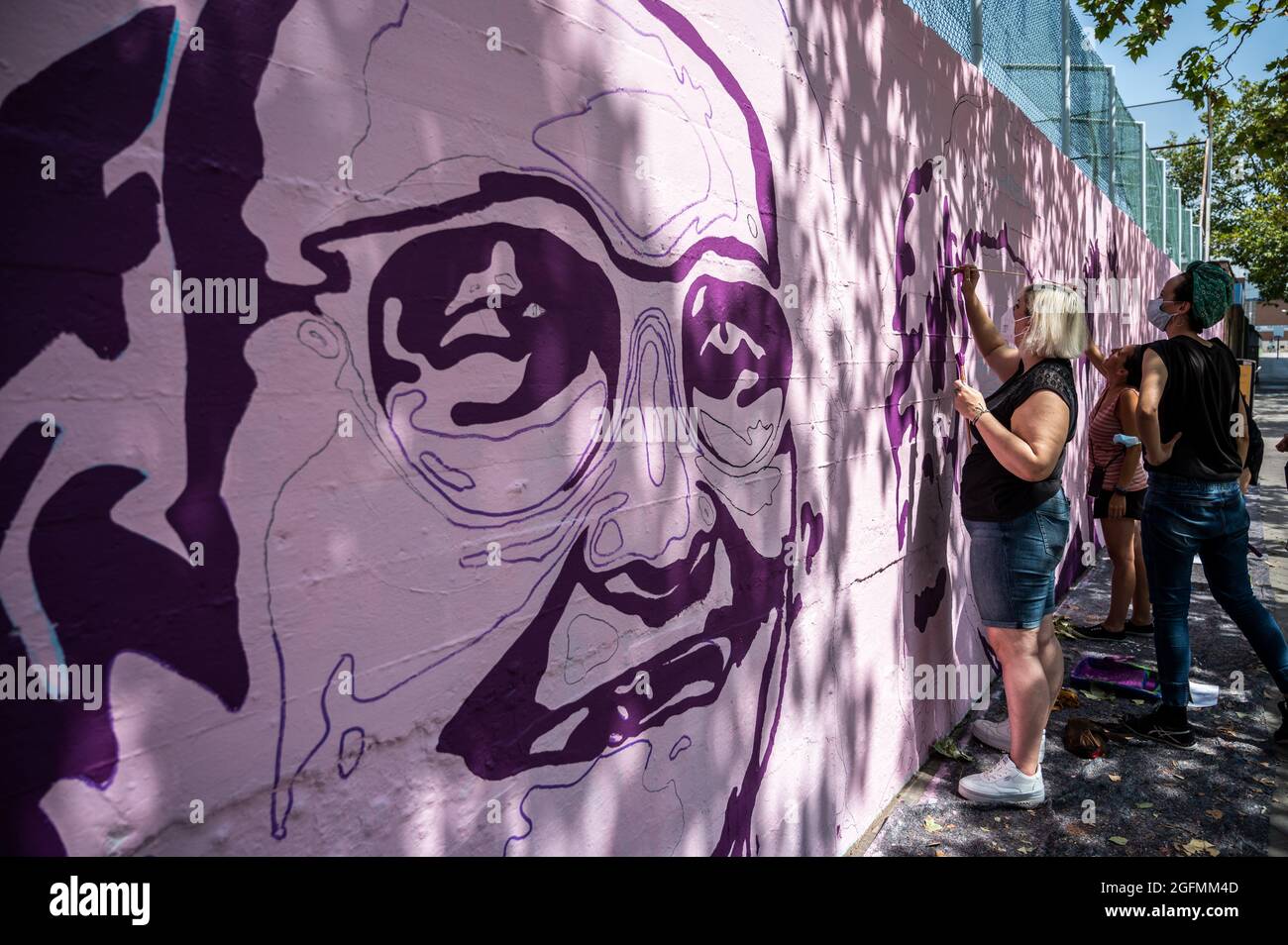 Madrid, Spain. 26th Aug, 2021. Members of UNLOGIC artistic group repainting a feminist mural that appeared vandalized during the past International Women's Day. The mural represents famous women from around the world, with the faces of 15 women who are part of history for their fight in favor of equality: Angela Davis, Frida Kahlo, Nina Simone, Rigoberta Menchu, Lucia Sanchez Saornil, Rosa Arauzo, Valentina Tereshkova, Chimamanda Ngozi, Emma Goldman, Kanno Sugato, Liudmila Pavlichenko, Billy Jean King, Gata Cattana, Rosa Parks, and Comandanta Ramona. Credit: Marcos del Mazo/Alamy Live News Stock Photo