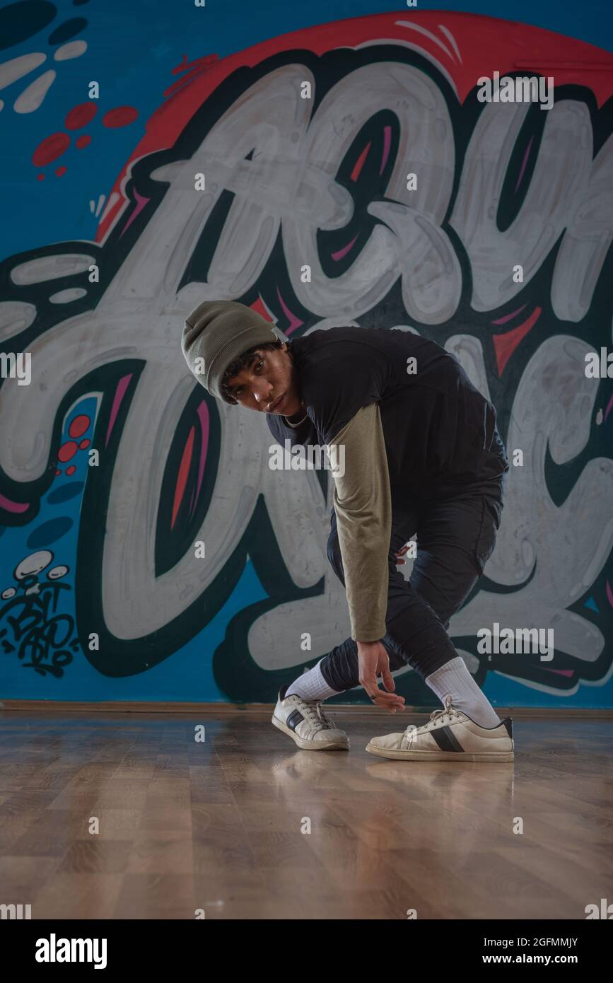 Modern rapper dancing in garage. Urban lifestyle, hip hop Stock Photo ...