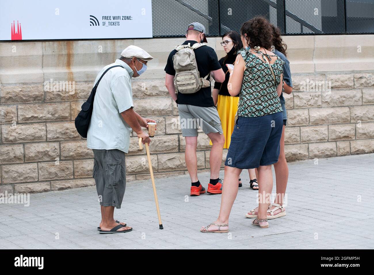 Romanian man begging from tourists, Sagrada Familia, Barcelona, Spain. Stock Photo