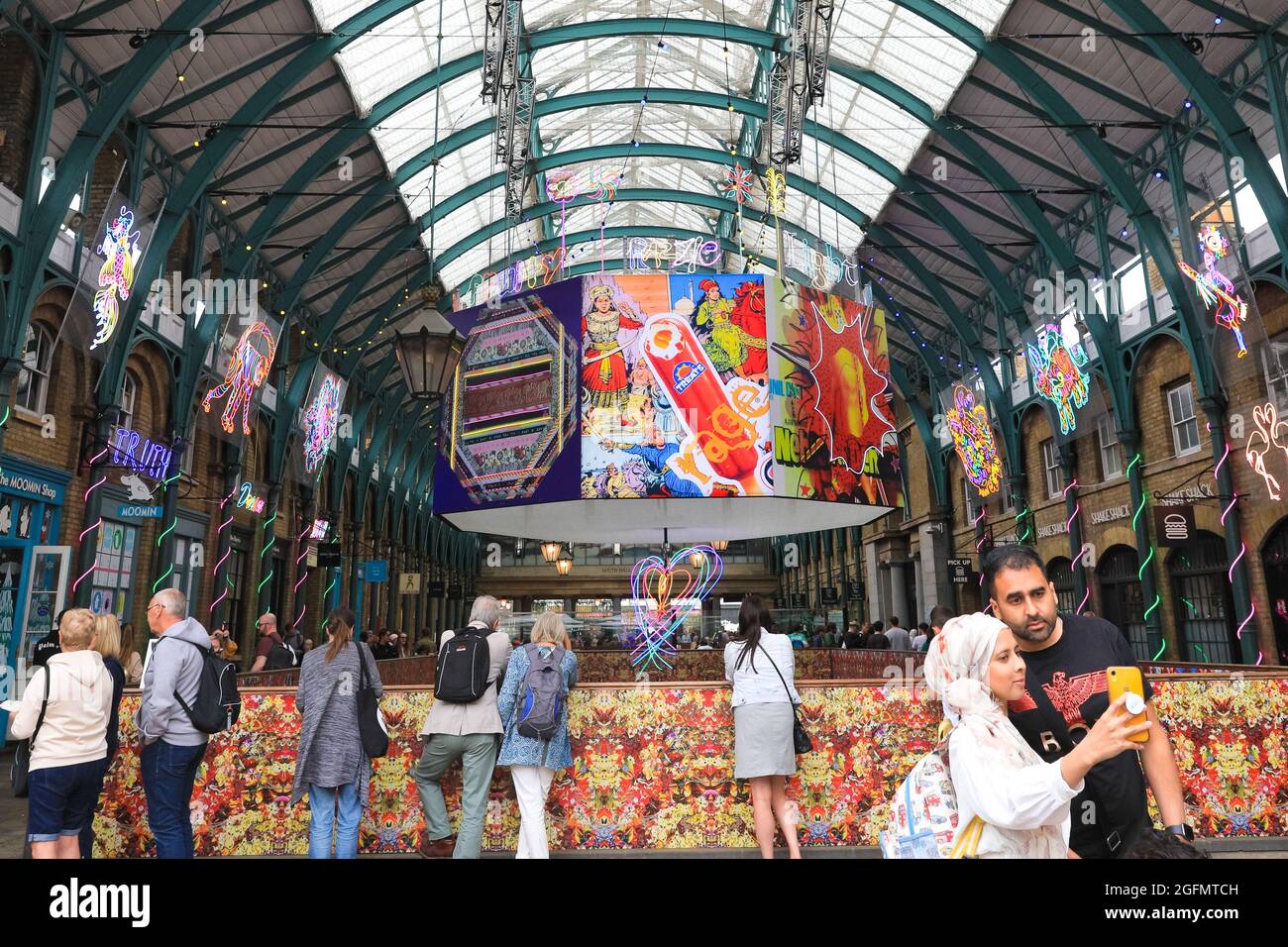 London, UK. 26th Aug, 2021. British artist Chila Burman´s latest art commission transforms London´s historic Covent Garden market halls into a neon wonderland, with vast neon sculpture and filled with uplifting messages for visitors. Credit: Imageplotter/Alamy Live News Stock Photo