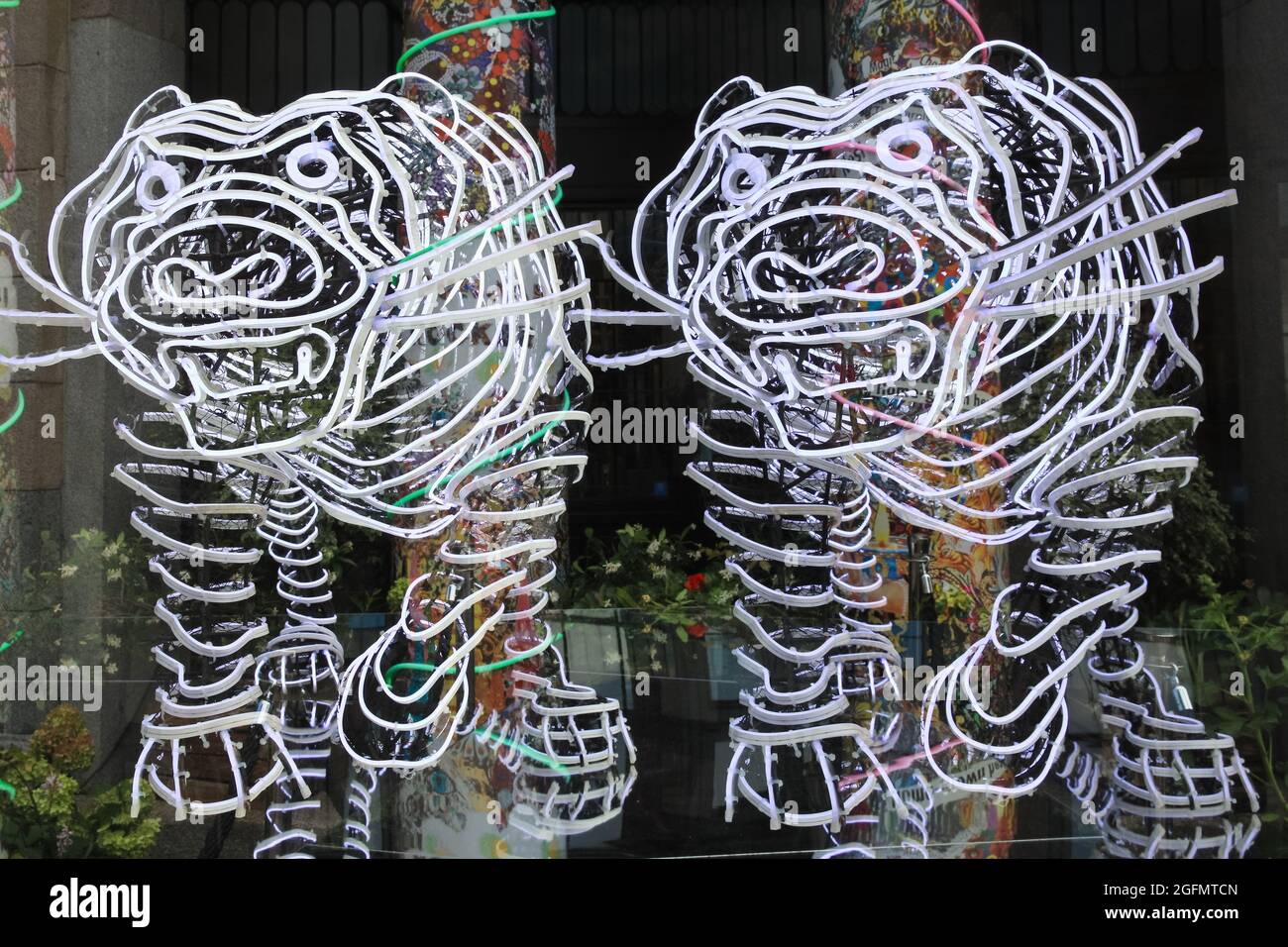 London, UK. 26th Aug, 2021. The tiger installation, multiple exposure. British artist Chila Burman´s latest art commission transforms London´s historic Covent Garden market halls into a neon wonderland, with vast neon sculpture and filled with uplifting messages for visitors. Credit: Imageplotter/Alamy Live News Stock Photo