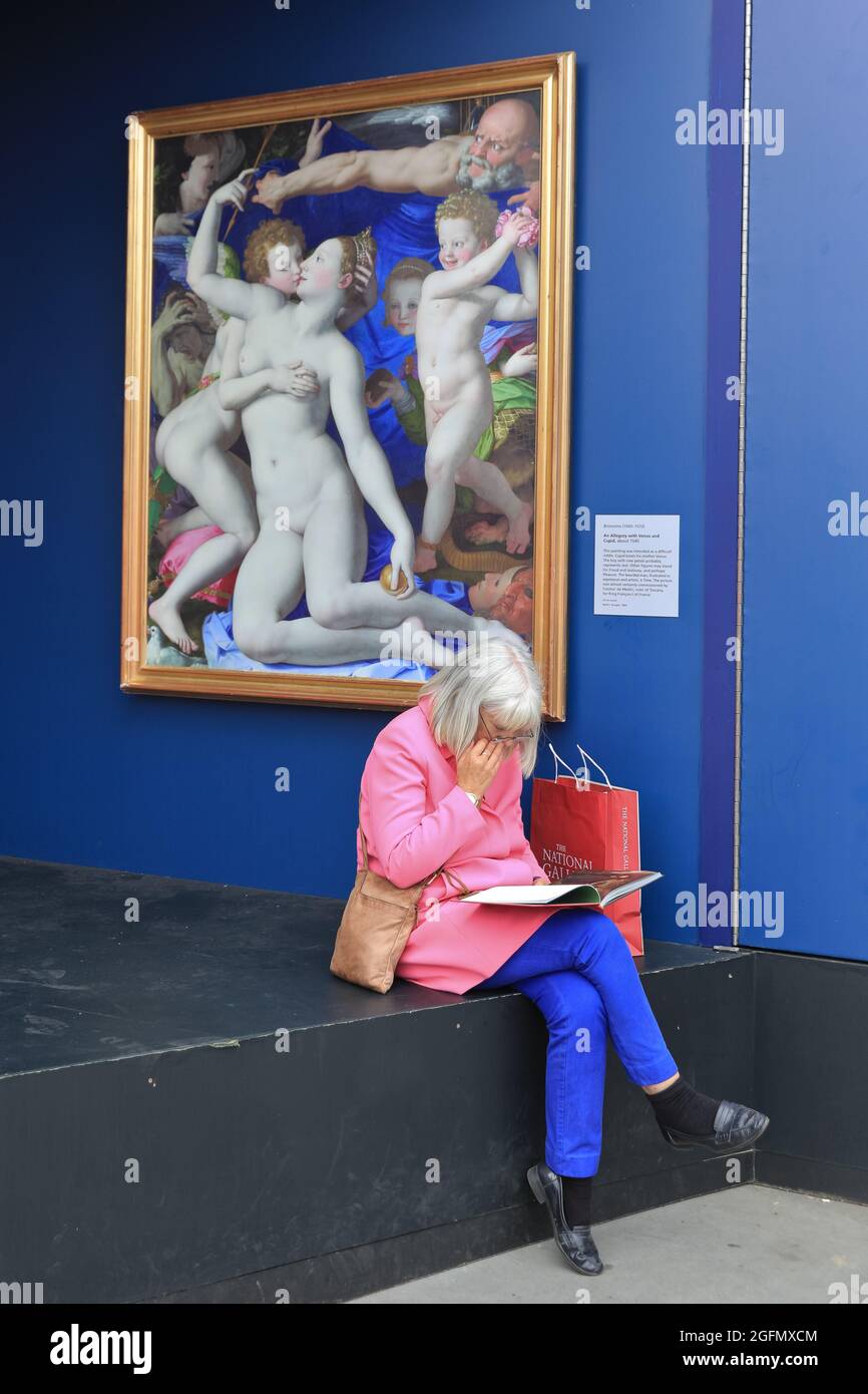 London, UK. 26th Aug, 2021. A woman blends in to the artwork and background at ´Nation´s Favourite Paintings´ on Trafalgar Square, which features 20 life-sized replicas of the Nation's Favourite Paintings and free community art sessions, the exhibits are in place until 31st August. Credit: Imageplotter/Alamy Live News Stock Photo
