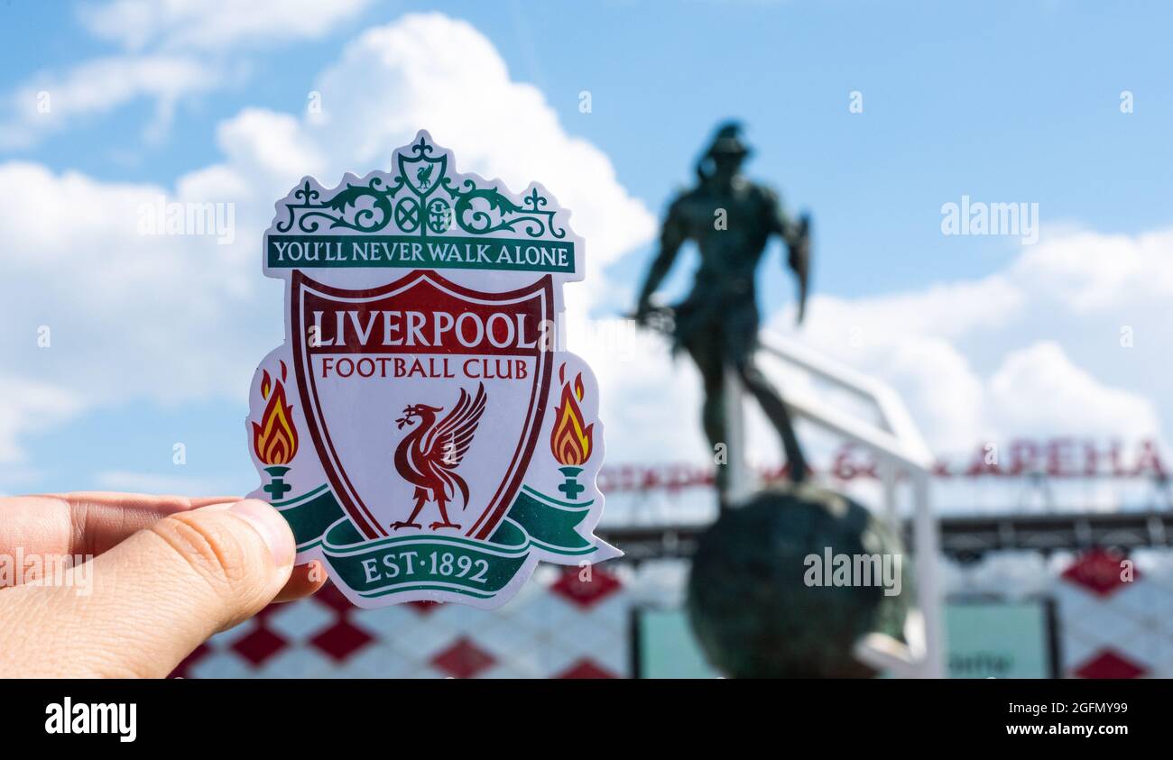 June 14, 2021 Liverpool, UK. Liverpool F.C. Football Club emblem against the backdrop of a modern stadium. Stock Photo