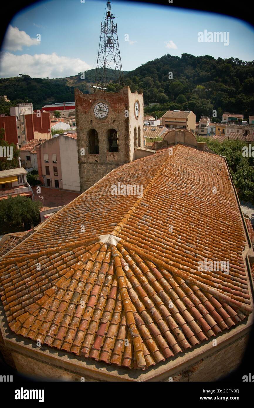 Church roofs with village houses and forests. Sky with clouds of varied colors. Stock Photo