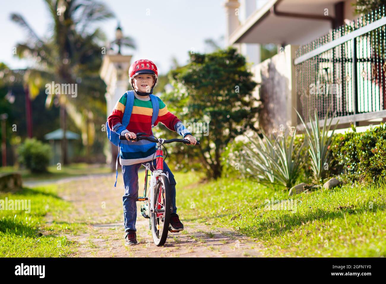 Child going to school on bike. Kids ride bicycle. Safe way to elementary school. Little boy with