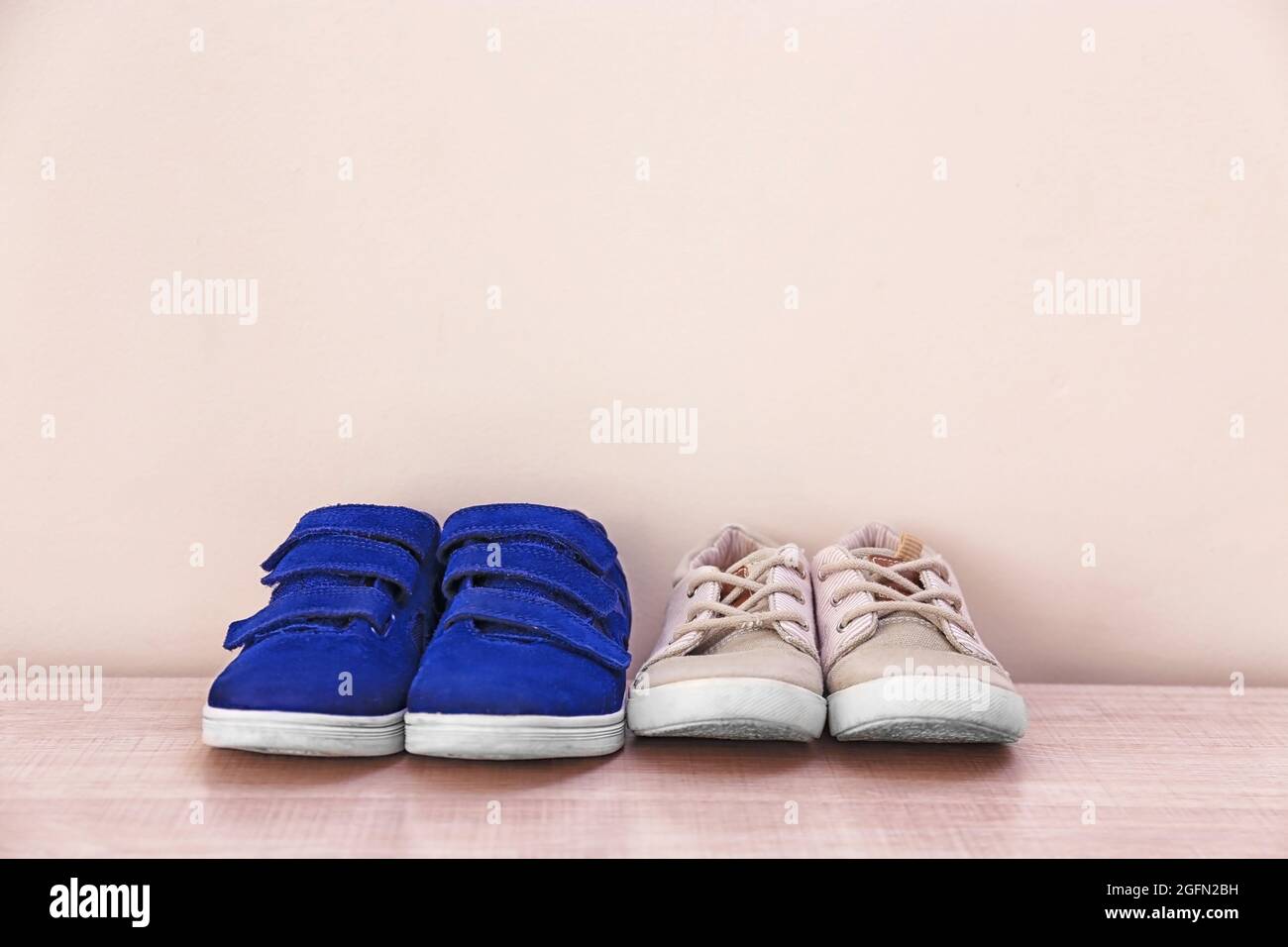 Baby shoes on big feet hi-res stock photography and images - Alamy