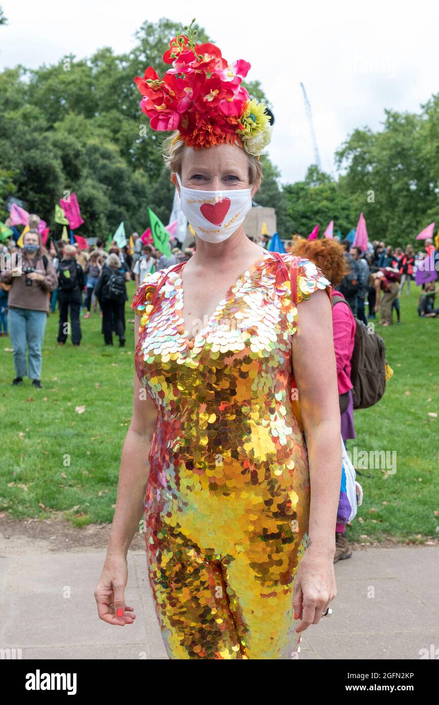 A protester seen in a glittery outfit during the protest.Extinction Rebellion's Impossible Rebellion protest continues as protesters march from Hyde Park in London under the theme 'Stop The Harm' against climate change, global warming, and plans to target the root cause of the climate and ecological crisis and to demand the government divest from fossil fuel companies. (Photo by Dave Rushen / SOPA Images/Sipa USA) Stock Photo