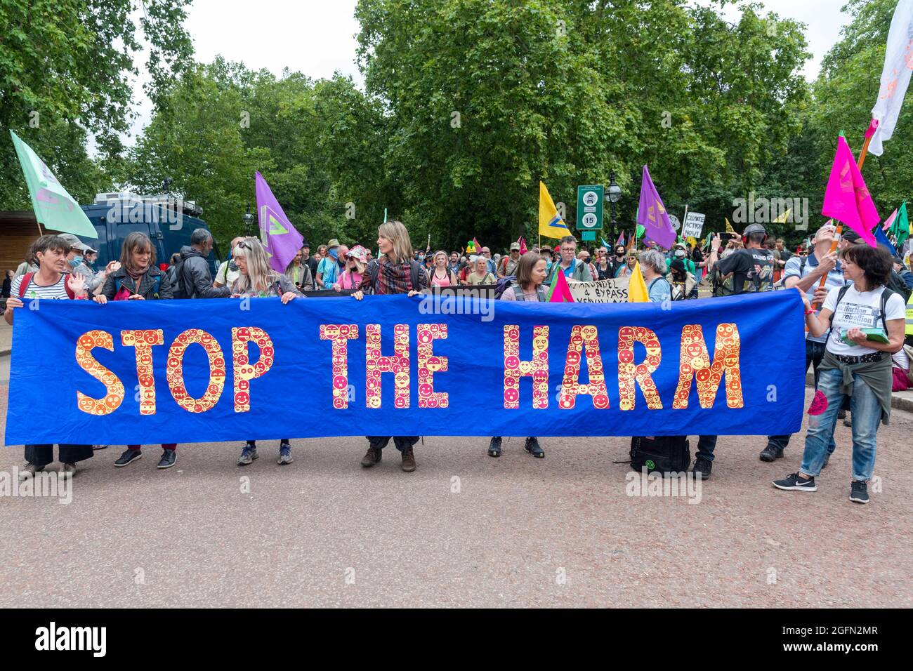 Protesters hold a banner reading 'Stop the Harm' during the protest march.Extinction Rebellion's Impossible Rebellion protest continues as protesters march from Hyde Park in London under the theme 'Stop The Harm' against climate change, global warming, and plans to target the root cause of the climate and ecological crisis and to demand the government divest from fossil fuel companies. (Photo by Dave Rushen / SOPA Images/Sipa USA) Stock Photo