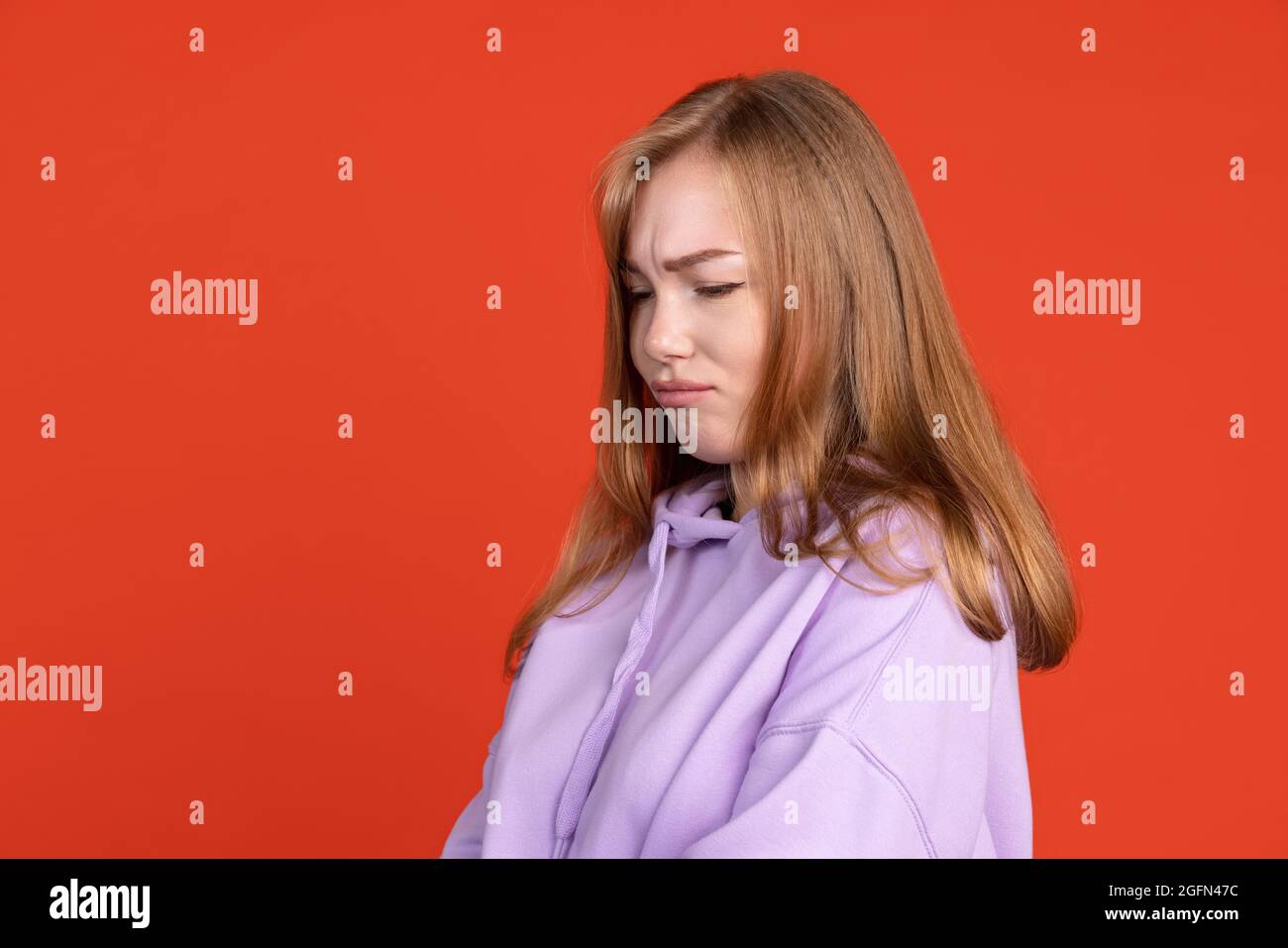 Half Length Portrait Of Young Girl Pouting Her Lips Isolated On Red