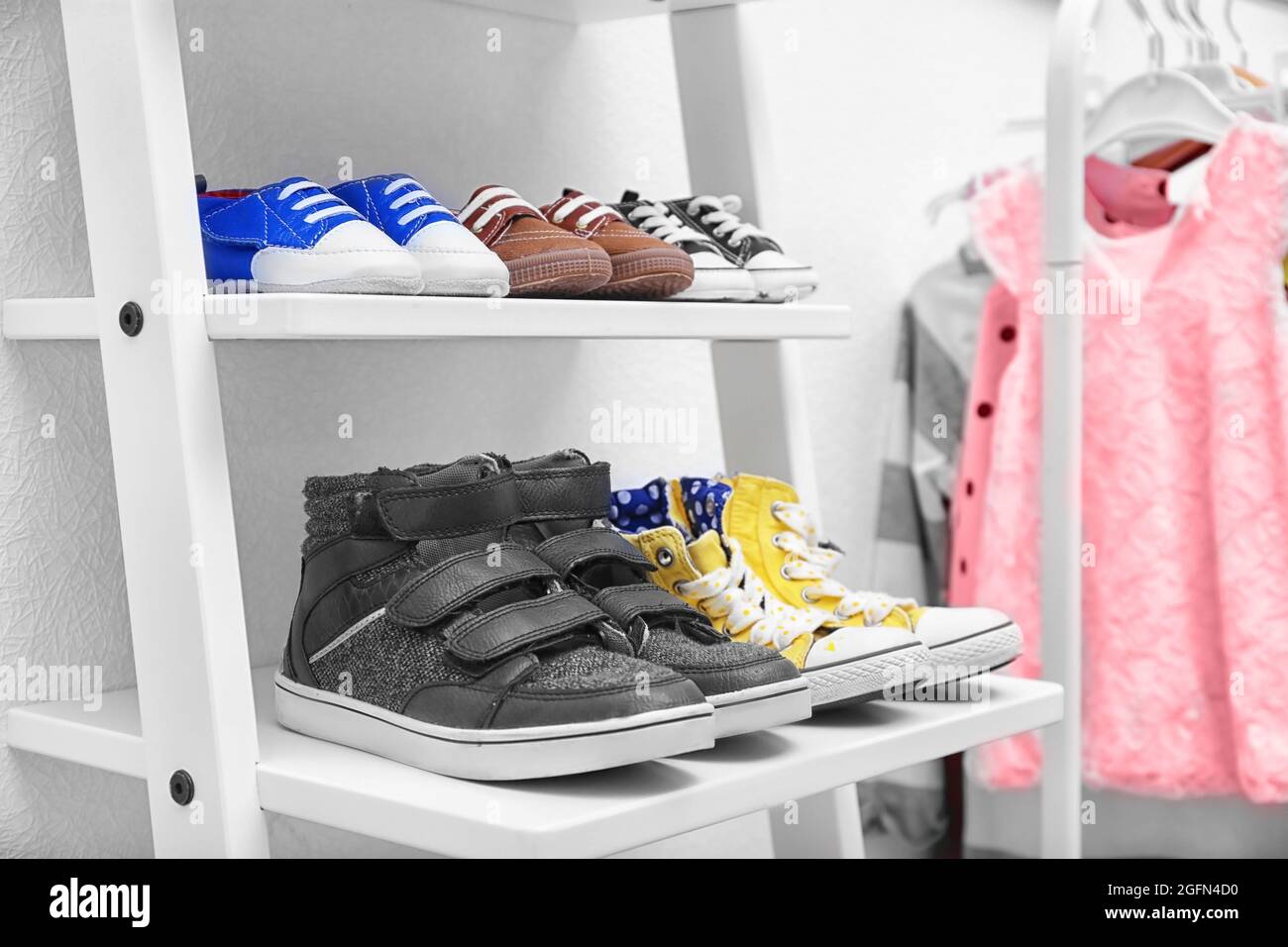 Different baby shoes on shelves indoors Stock Photo Alamy