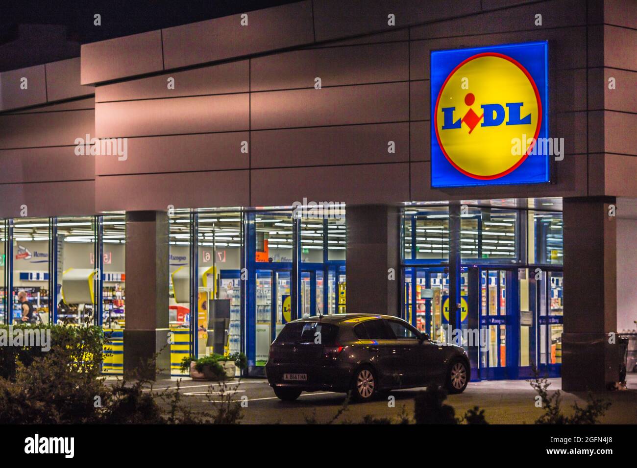 View of Lidl supermarket and logo in the night.Lidl Stiftung & Co. KG is a German global discount supermarket chain,operating in 26 European countries Stock Photo