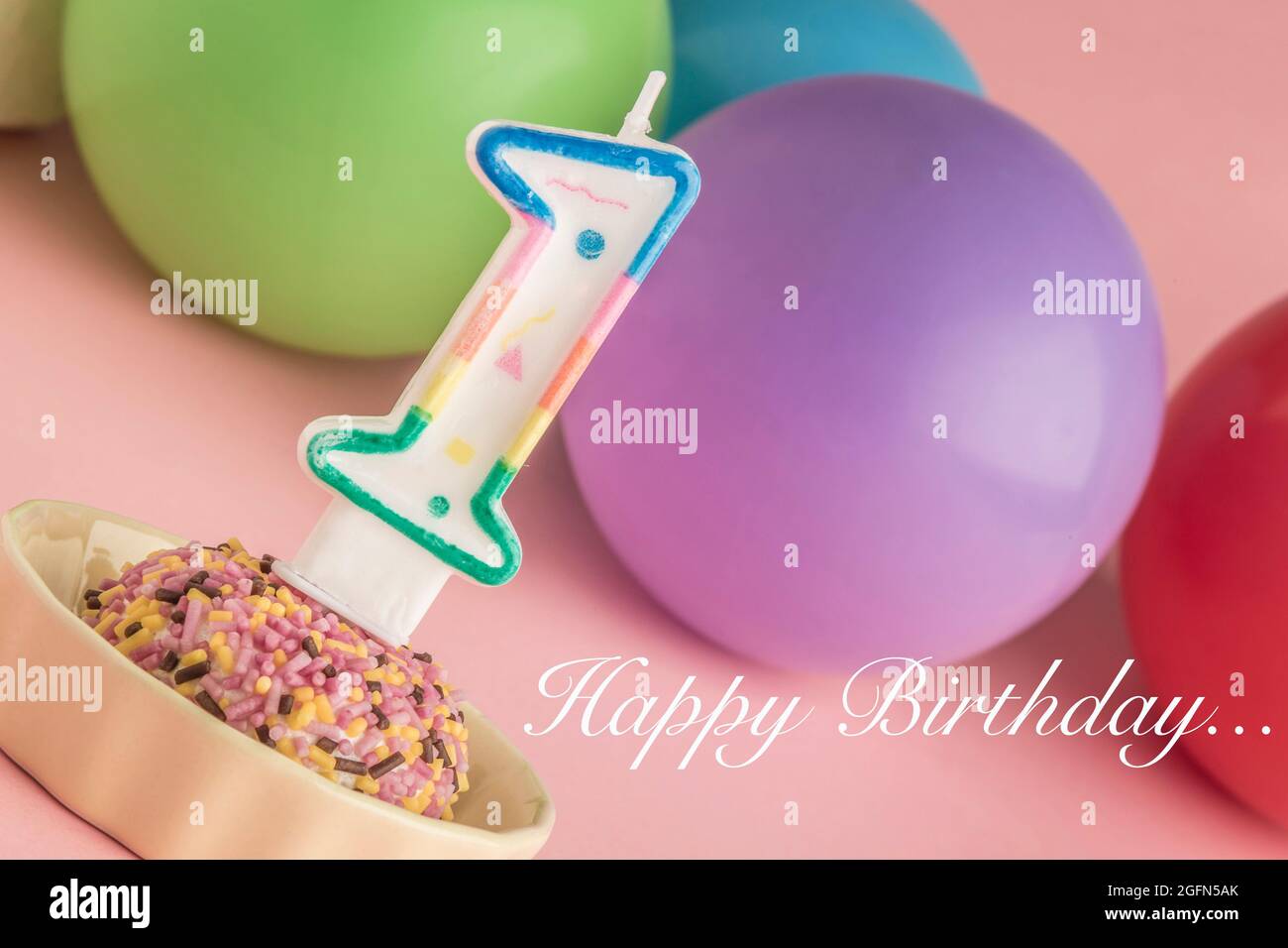 A small birthday cake with one candle on pink Stock Photo - Alamy