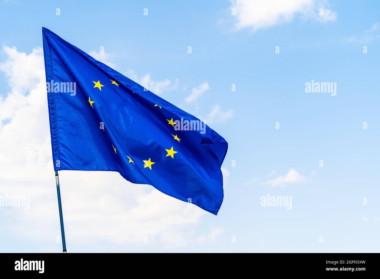 European Union flag against blue sky waving Stock Photo - Alamy