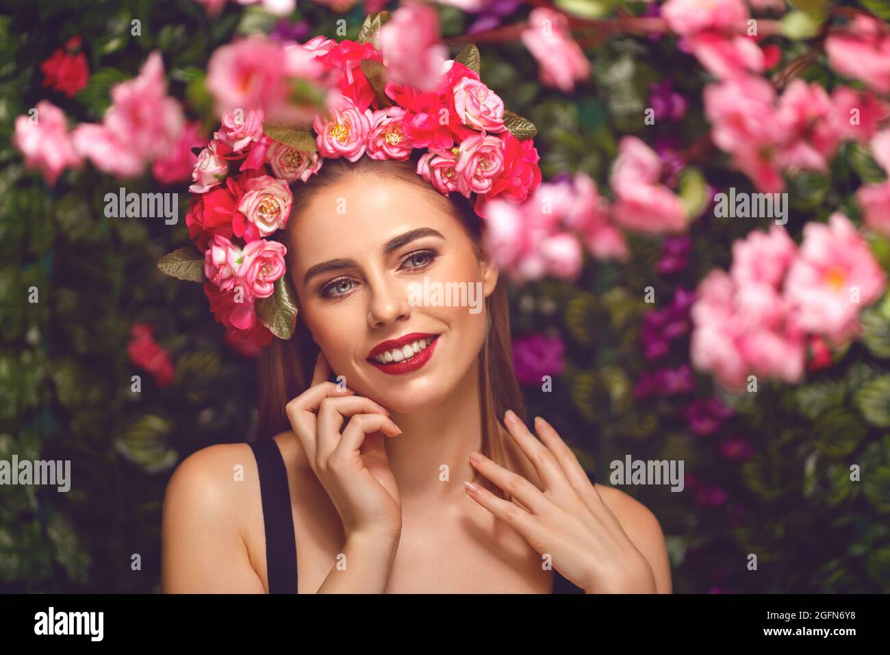 Beautiful young woman beauty and fashion portrait with wreath headband in flowers garden Stock Photo