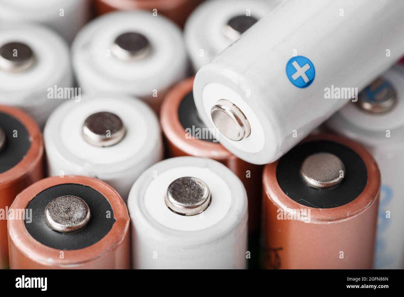 Rechargeable AA batteries with white and positive polarity. Selective focus Stock Photo