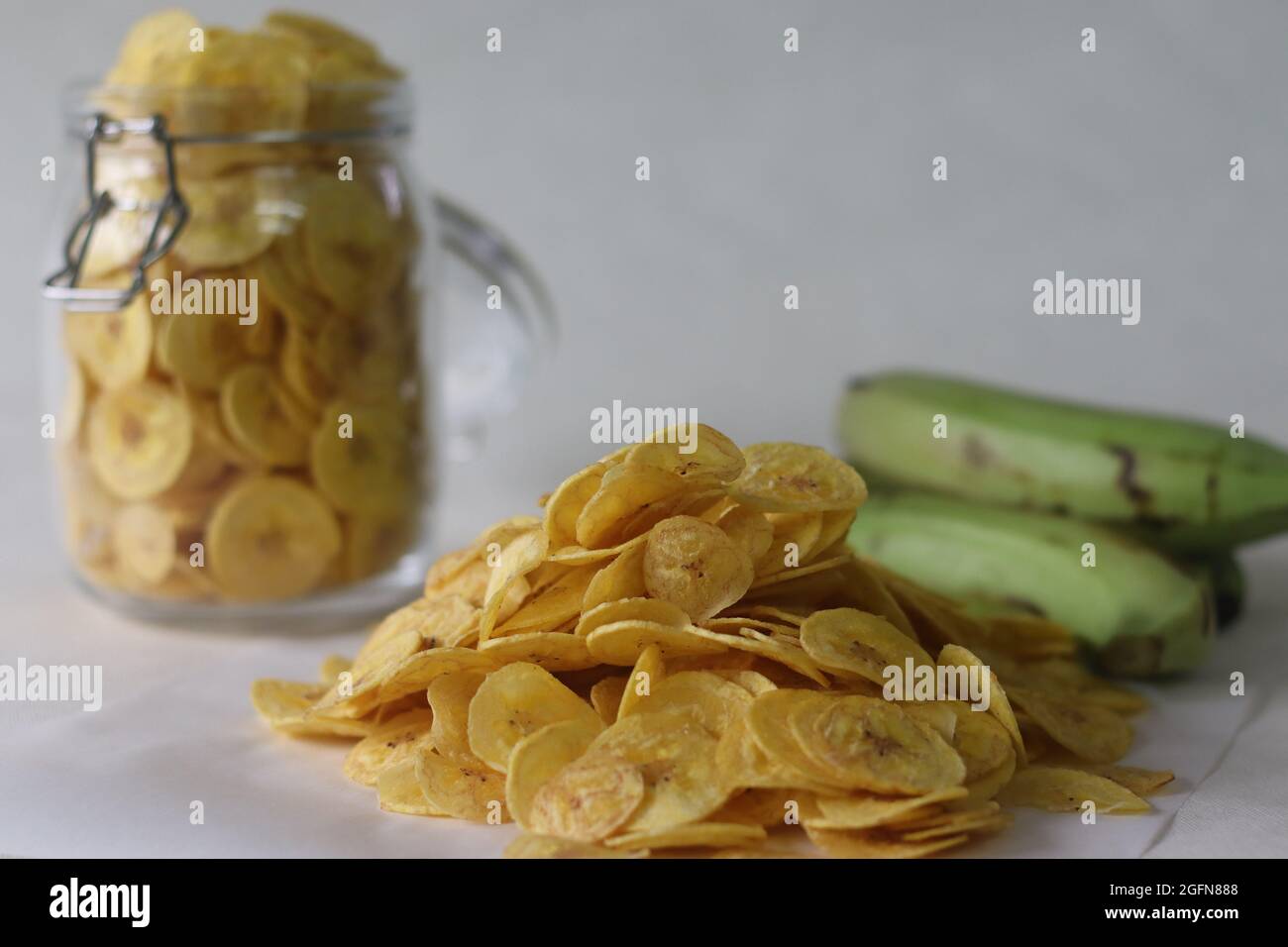 Fried banana chips made by deep frying under ripe banana slices. A main