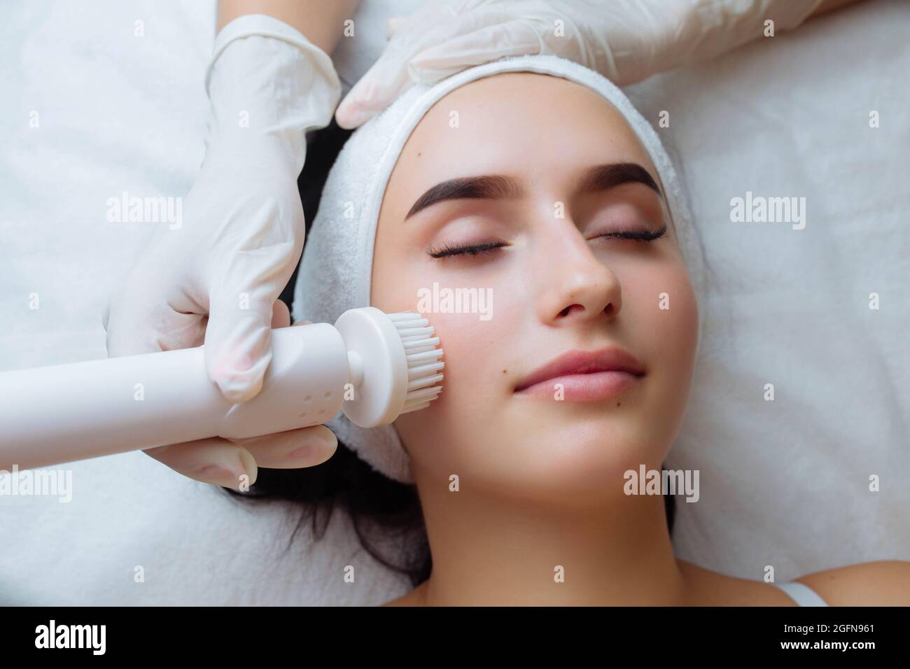 Facial massage. Care skin brushing spa procedure and cosmetology Stock Photo