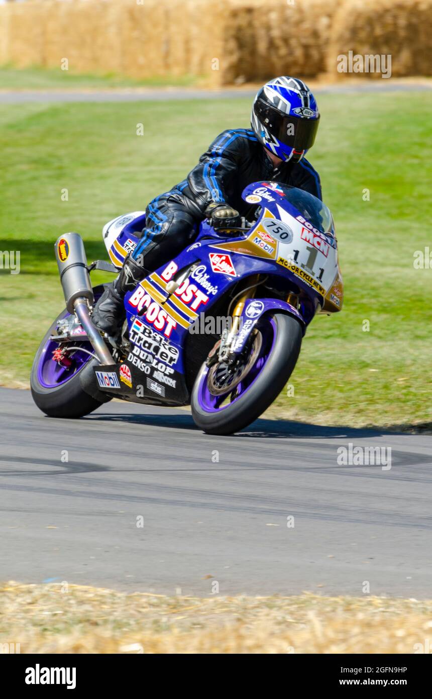 Niall MacKenzie's 1996 Yamaha YZF750 Cadbury Boost Superbike motorcycle racing up the hill climb track at the Goodwood Festival of Speed event 2014 Stock Photo