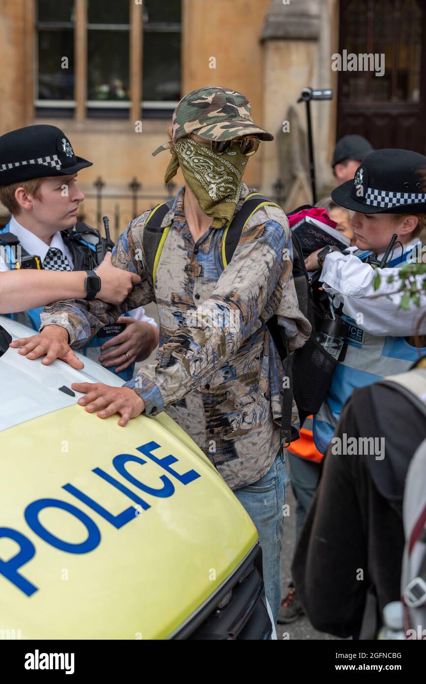 London, UK. 26th Aug, 2021. Police stop and search a male protester during the Extinction Rebellion's Impossible Rebellion protest outside the Department for Business Energy and Industrial Strategy, the man was then released. Credit: SOPA Images Limited/Alamy Live News Stock Photo