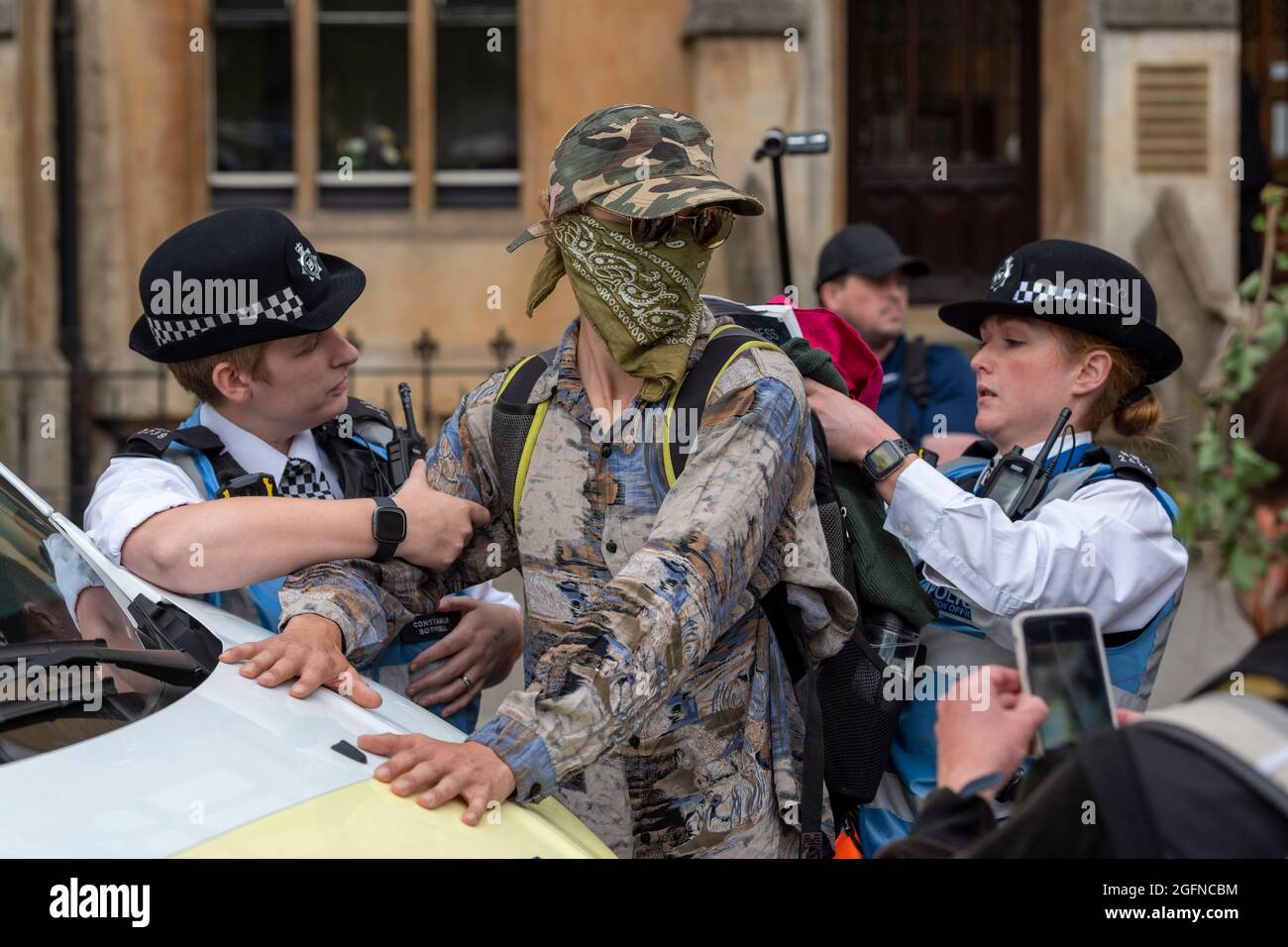 London, UK. 26th Aug, 2021. Police stop and search a male protester during the Extinction Rebellion's Impossible Rebellion protest outside the Department for Business Energy and Industrial Strategy, the man was then released. Credit: SOPA Images Limited/Alamy Live News Stock Photo