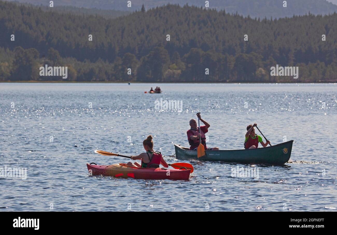 Badenoch and Strathspey, Loch Morlich,near Aviemore,Scotland, UK weather. 26th August 2021. Pictured: People enjoying watersports in the late afternoon sunshine, temperature 18 degrees at the loch. Credit: Arch White/Alamy Live news. Stock Photo