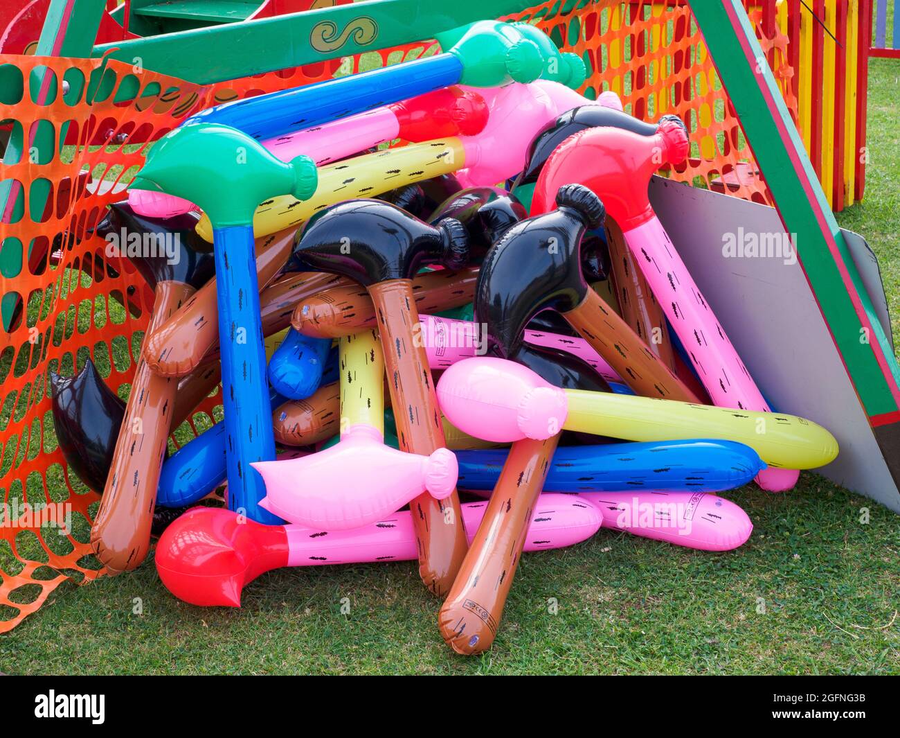 Pile of inflatable plastic hammers, prizes at a fairground stall, Bude, Cornwall, UK Stock Photo