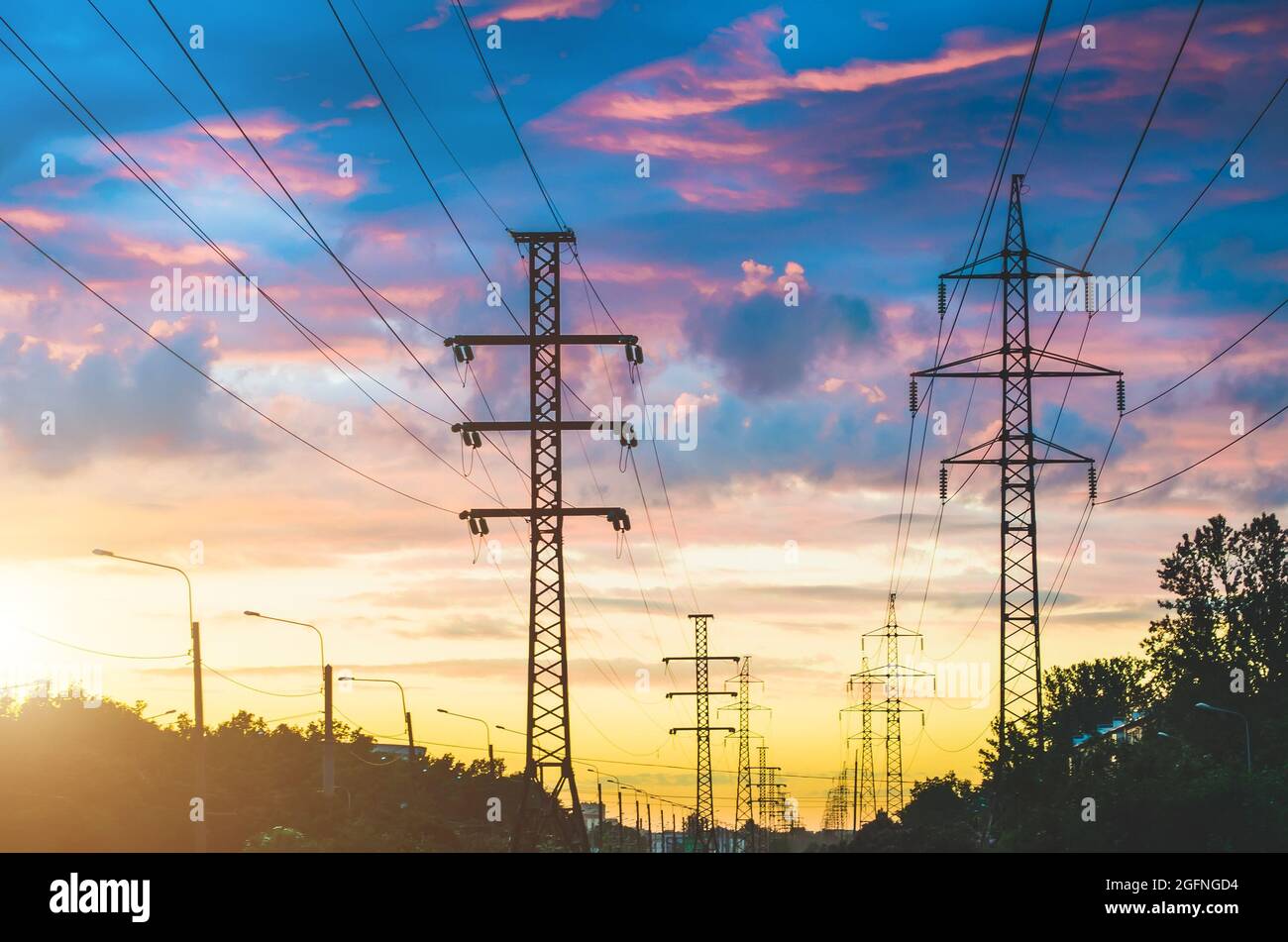 Power lines, sunset evening sky and perspective street in the city ...
