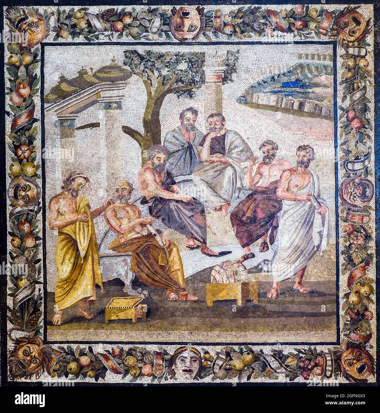 Plato's academy Mosaic emblema in opus vermiculatum made from polychrome tesserae. The mosaic depicts a group of philosophers, identifiable from their clothes and the symbols of their science, who are deep in discussion beneath a tree, between a votive column and a sacred gate with vases. In the distance there is a walled city. The scene is surrounded by a festoon of leaves and fruits, adorned with ribbons and comic masks. Pompeii, Villa of T. Siminius Stephanus Early 1st century BC Stock Photo
