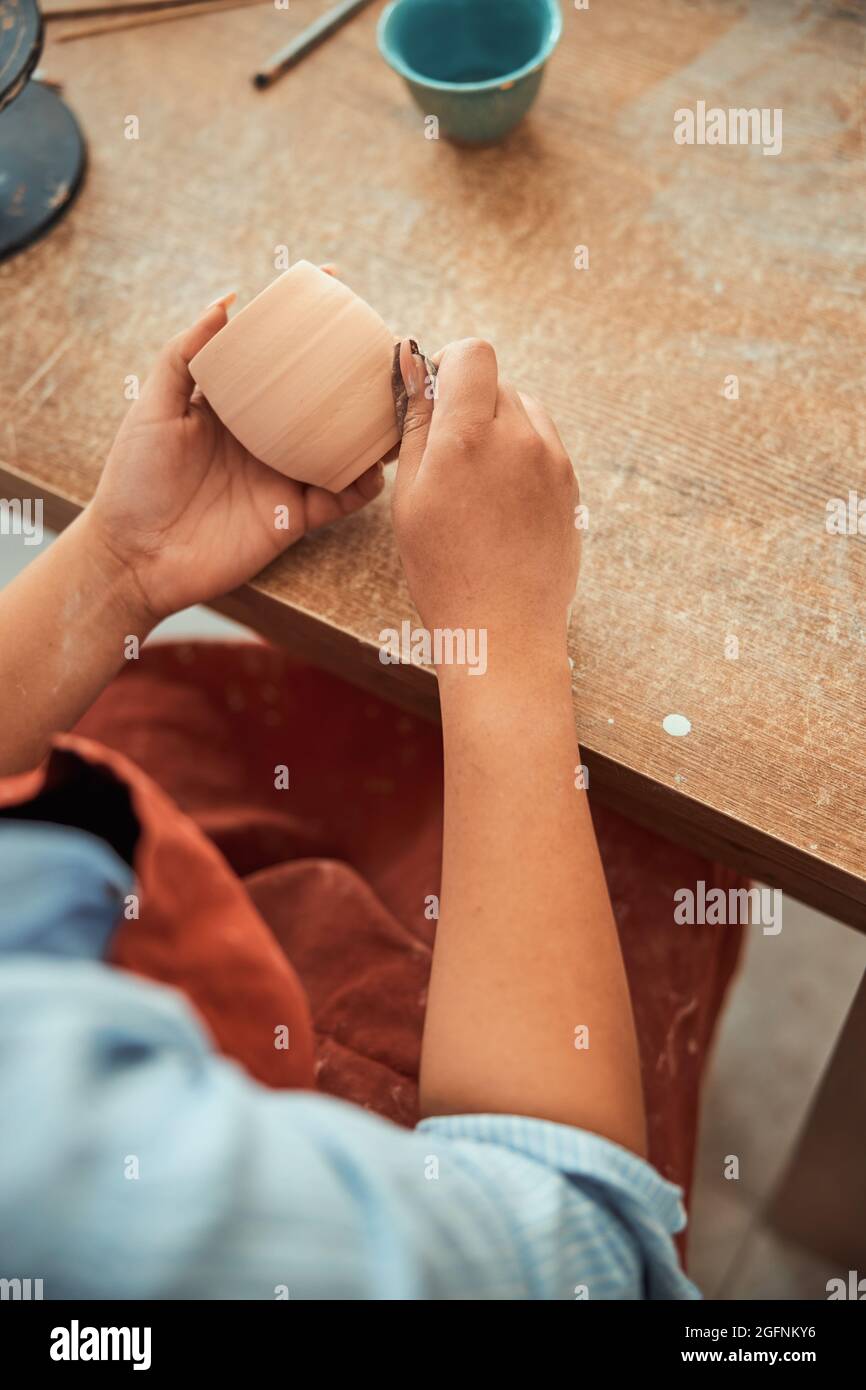 Female potter polishing clay pot in pottery Stock Photo Alamy